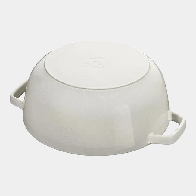 White cast iron pot flipped on a white background