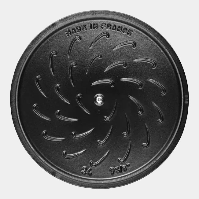 Black cast iron lid under view with 'Made in France' text on a white background