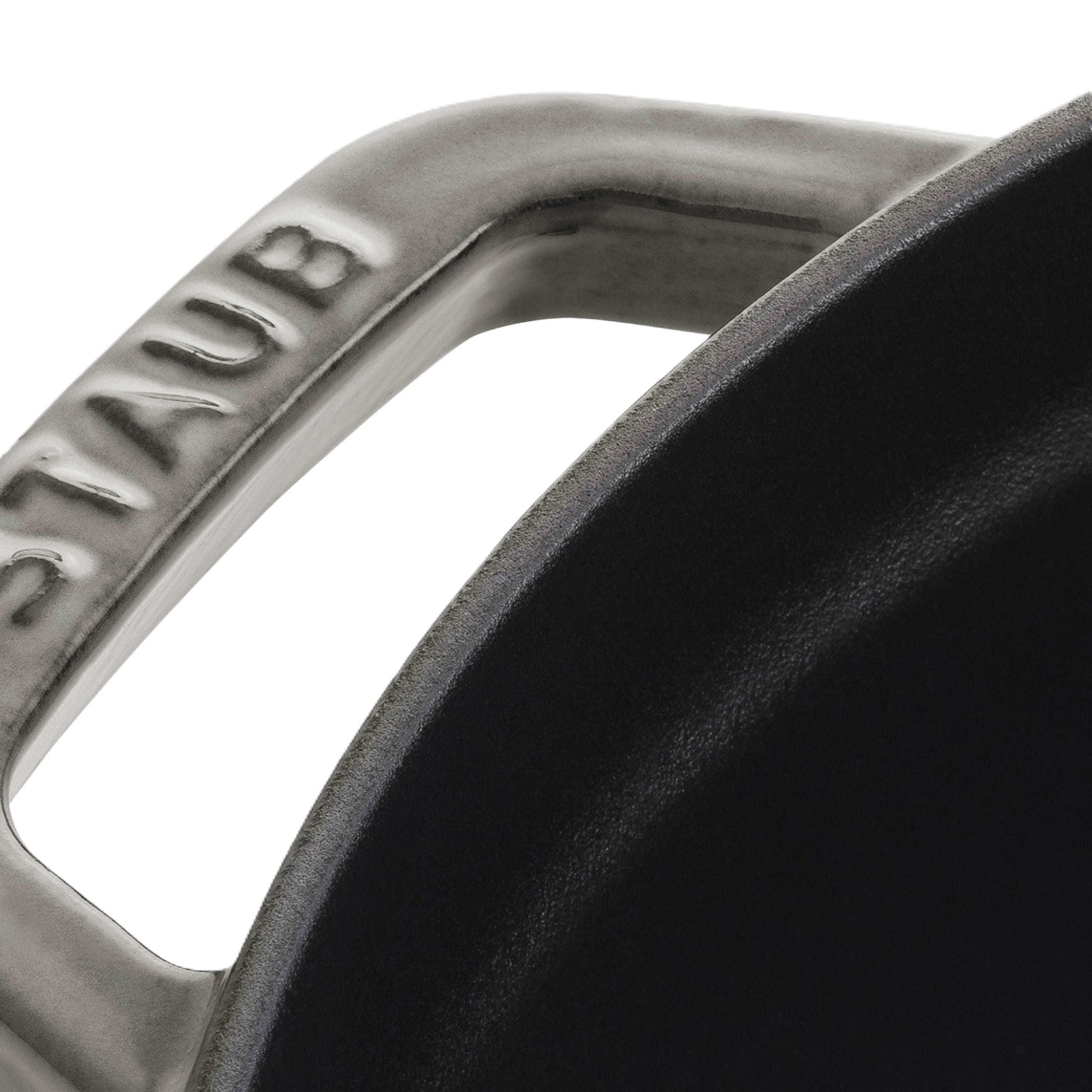 Close-up of a Staub cookware handle with brand name.