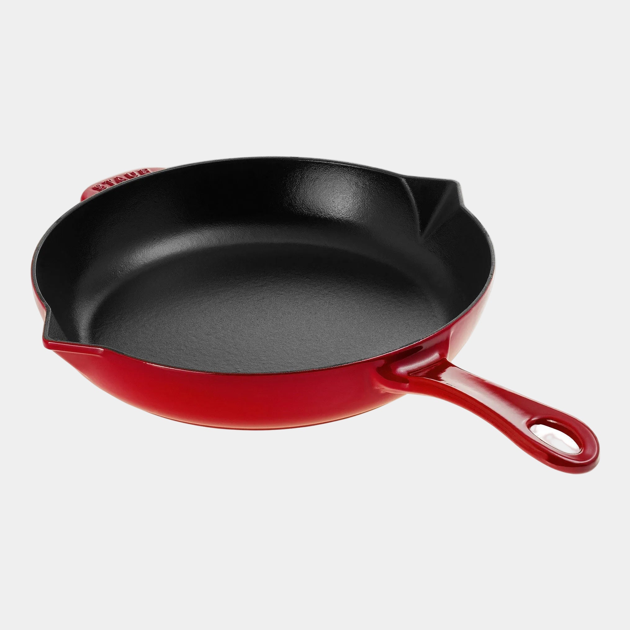 Red cast iron skillet on a white background