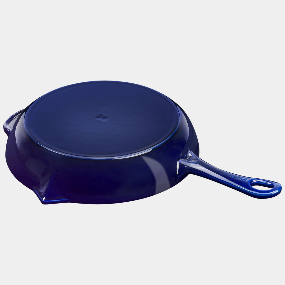 Blue cast iron skillet on a white background