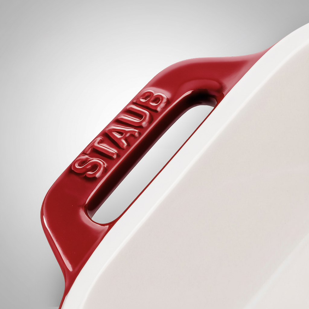 Close-up of STAUB Ceramique Ceramic Rectangular Oven Dish handle showcasing the cherry red design and logo.