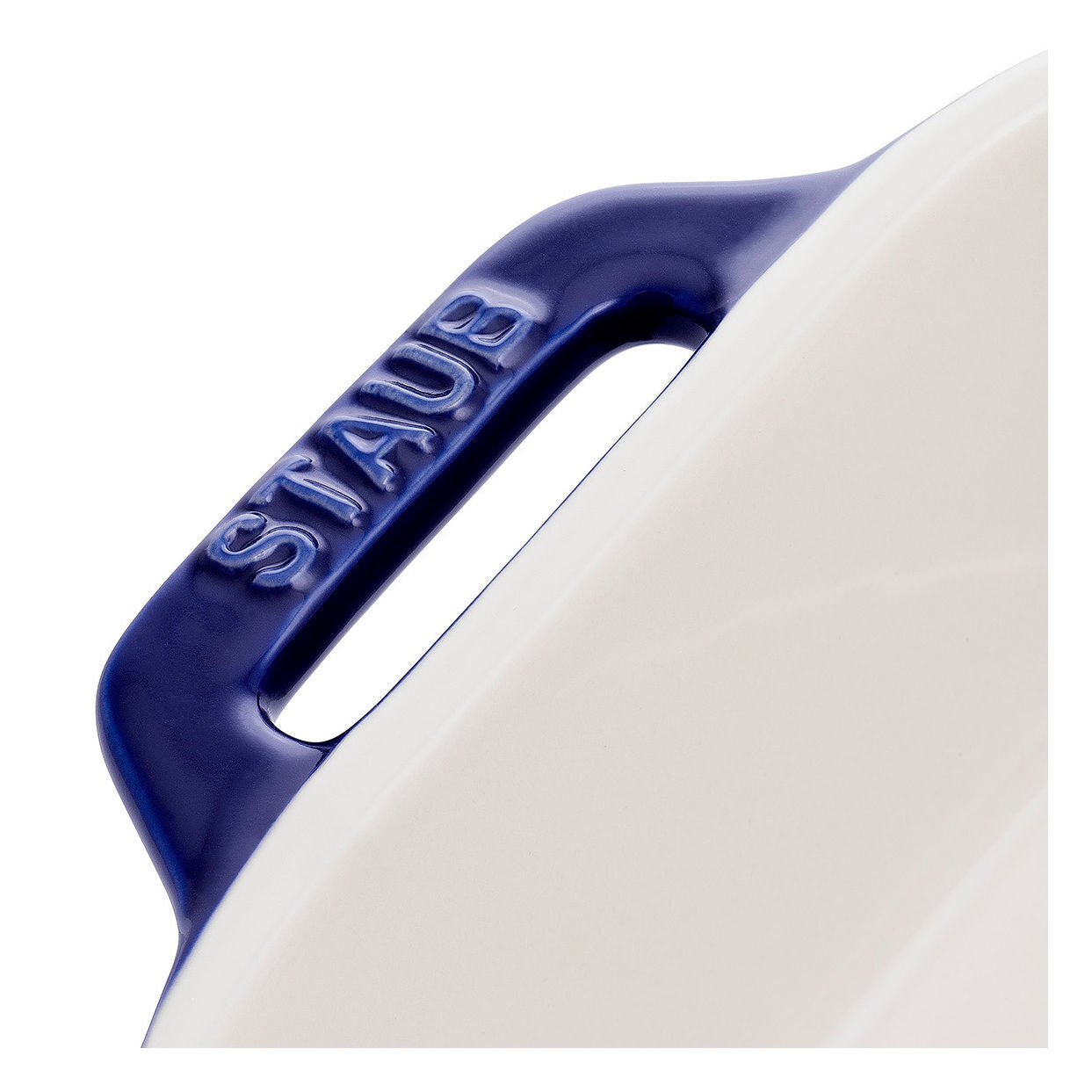 Staub ceramic cookware handle with blue handle and white body on a white background