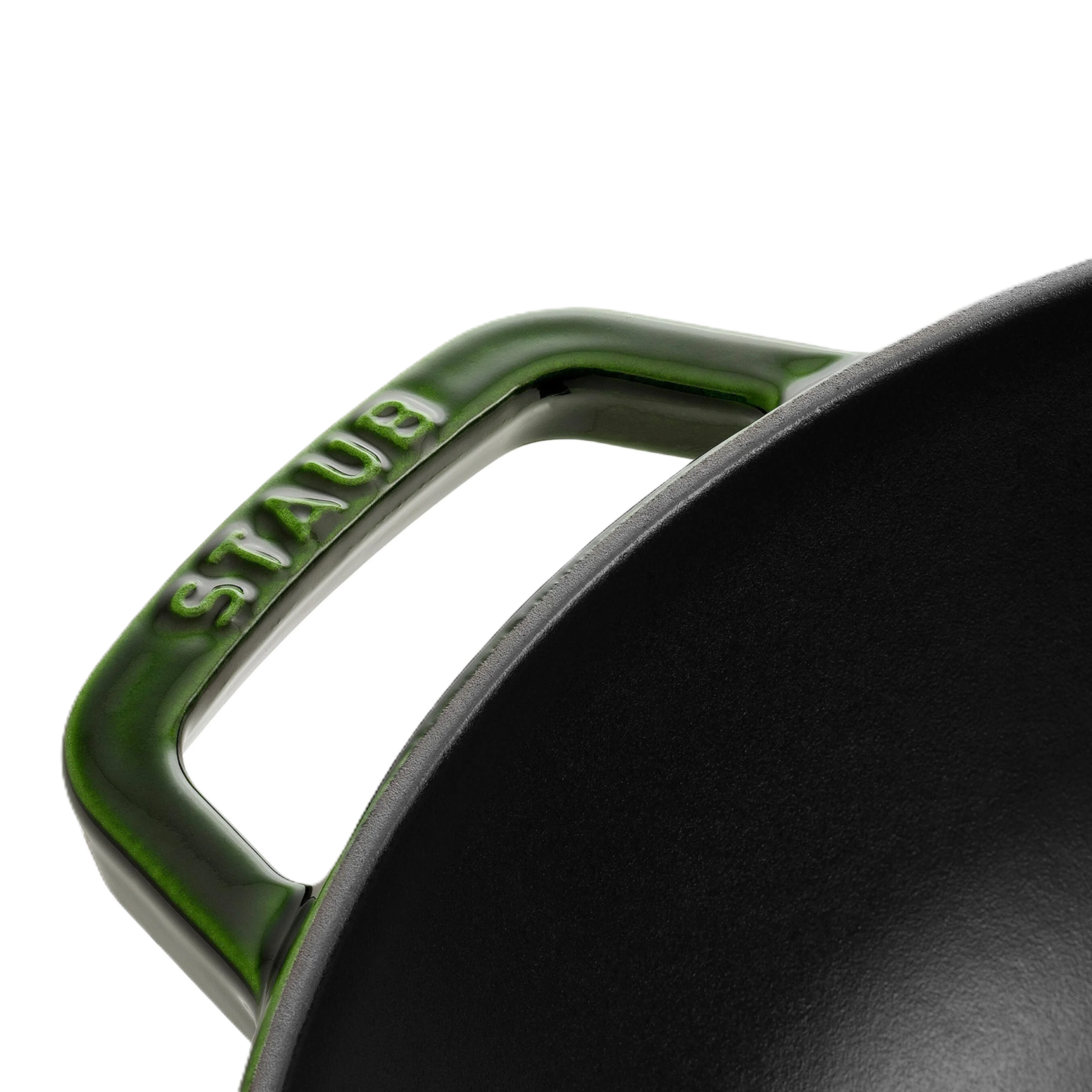 Close-up of a green Staub handle on a black pot.