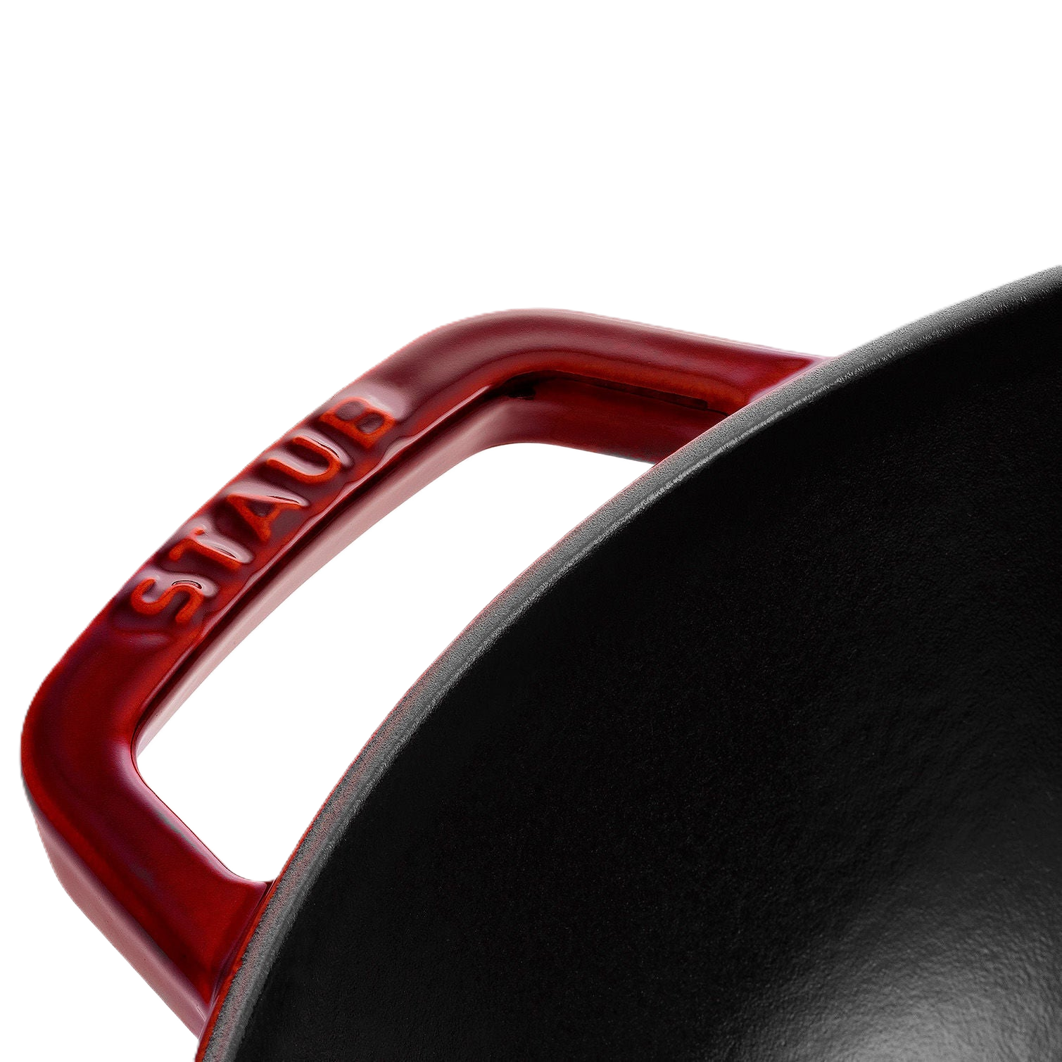 Close-up of a red Staub handle on a black pot with a white background