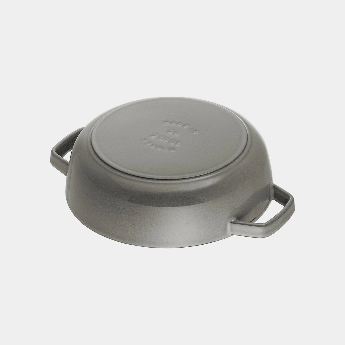 Gray cast iron pan fliped on a white background