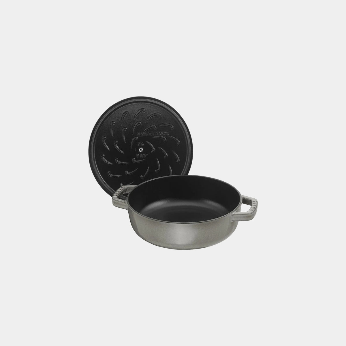 Black cast iron pot with lid on a white background