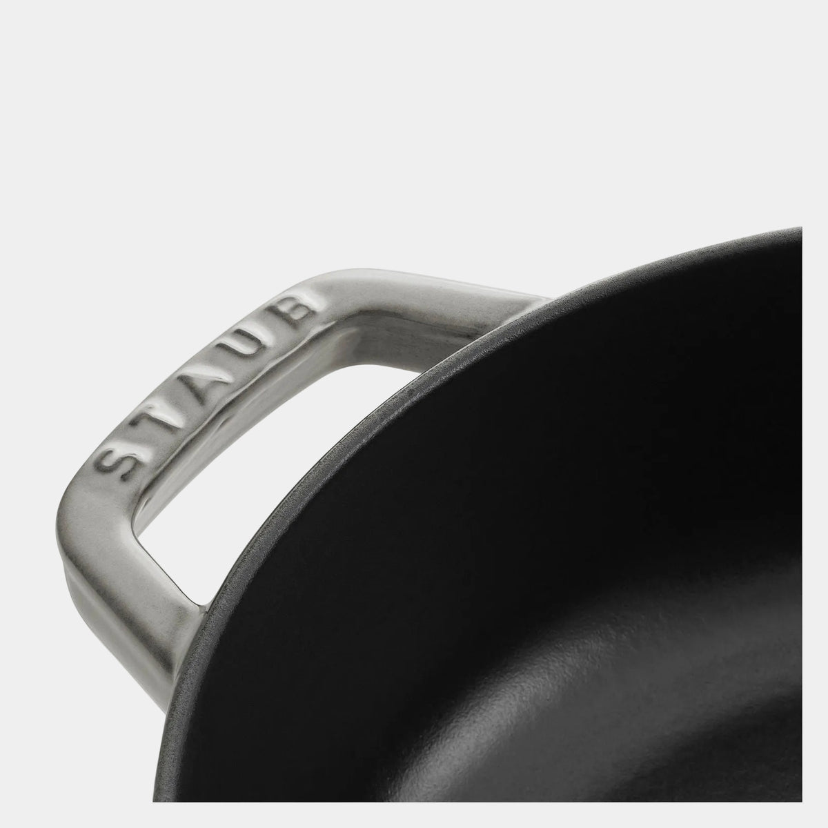 Close-up of a Staub cookware handle on a white background