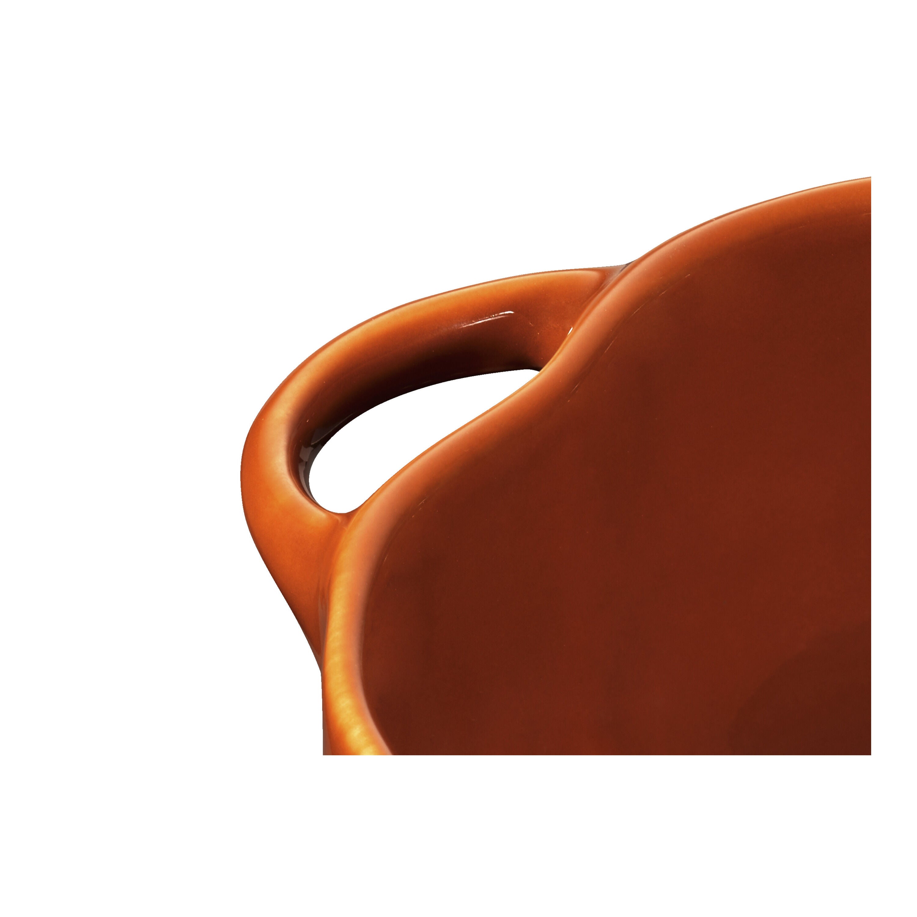 Close-up of the handle on the STAUB Ceramique Ceramic Pumpkin Cocotte in Cinnamon color.