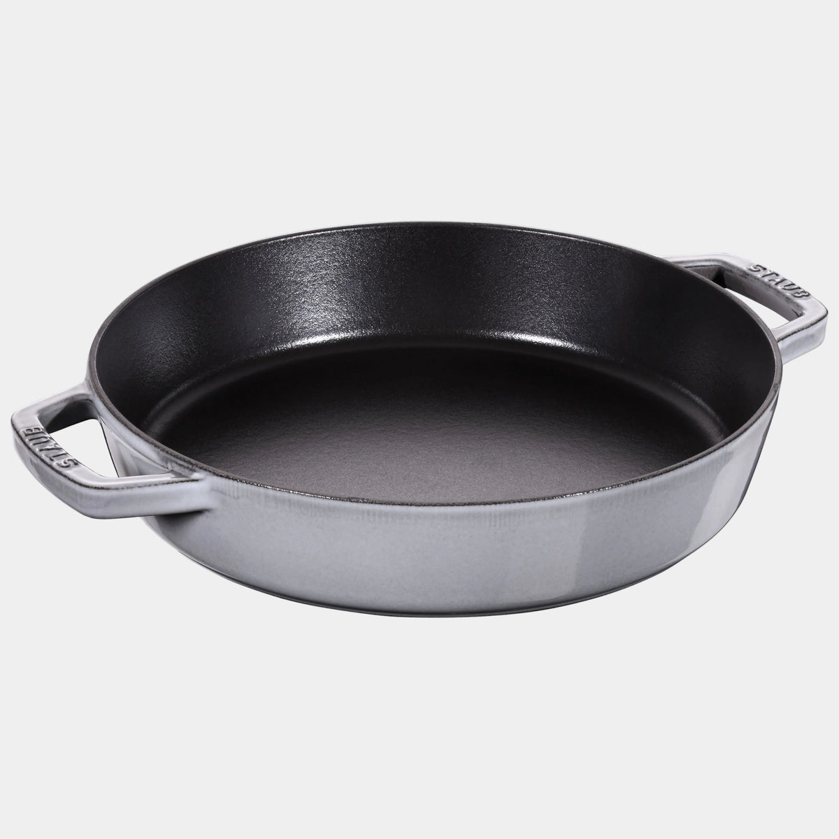 Black cast iron skillet on a white background