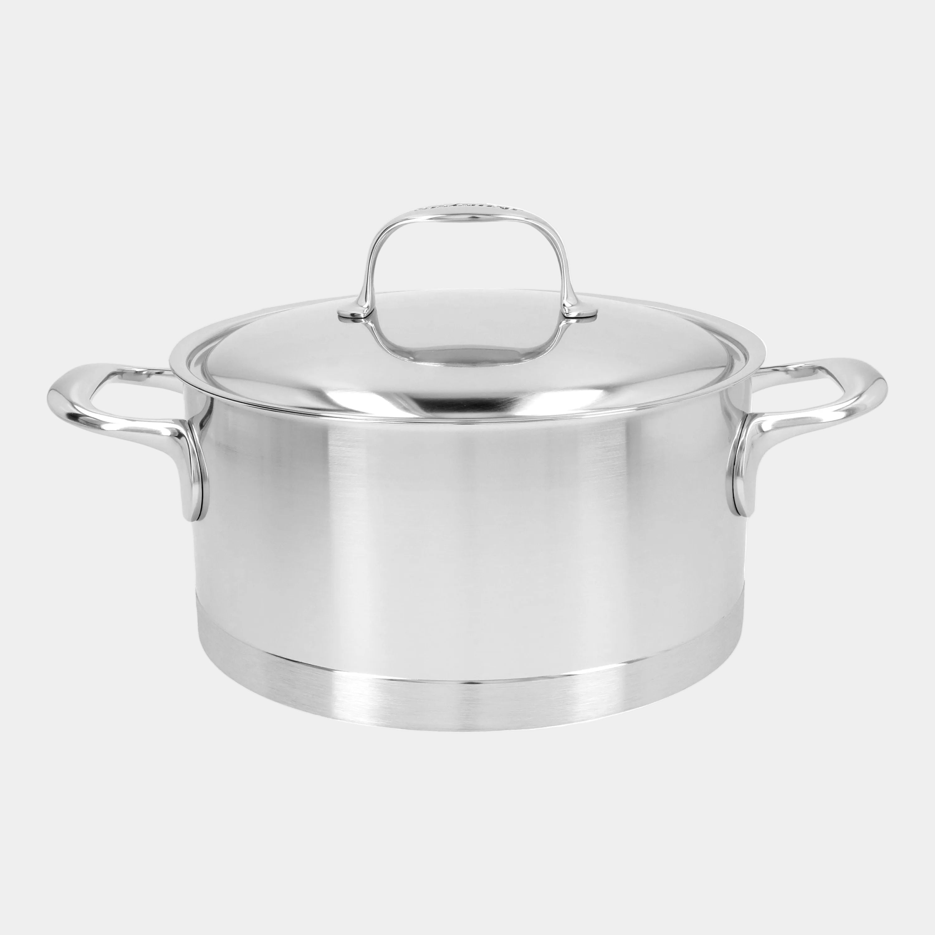 Stainless steel stock pot with lid on a white background