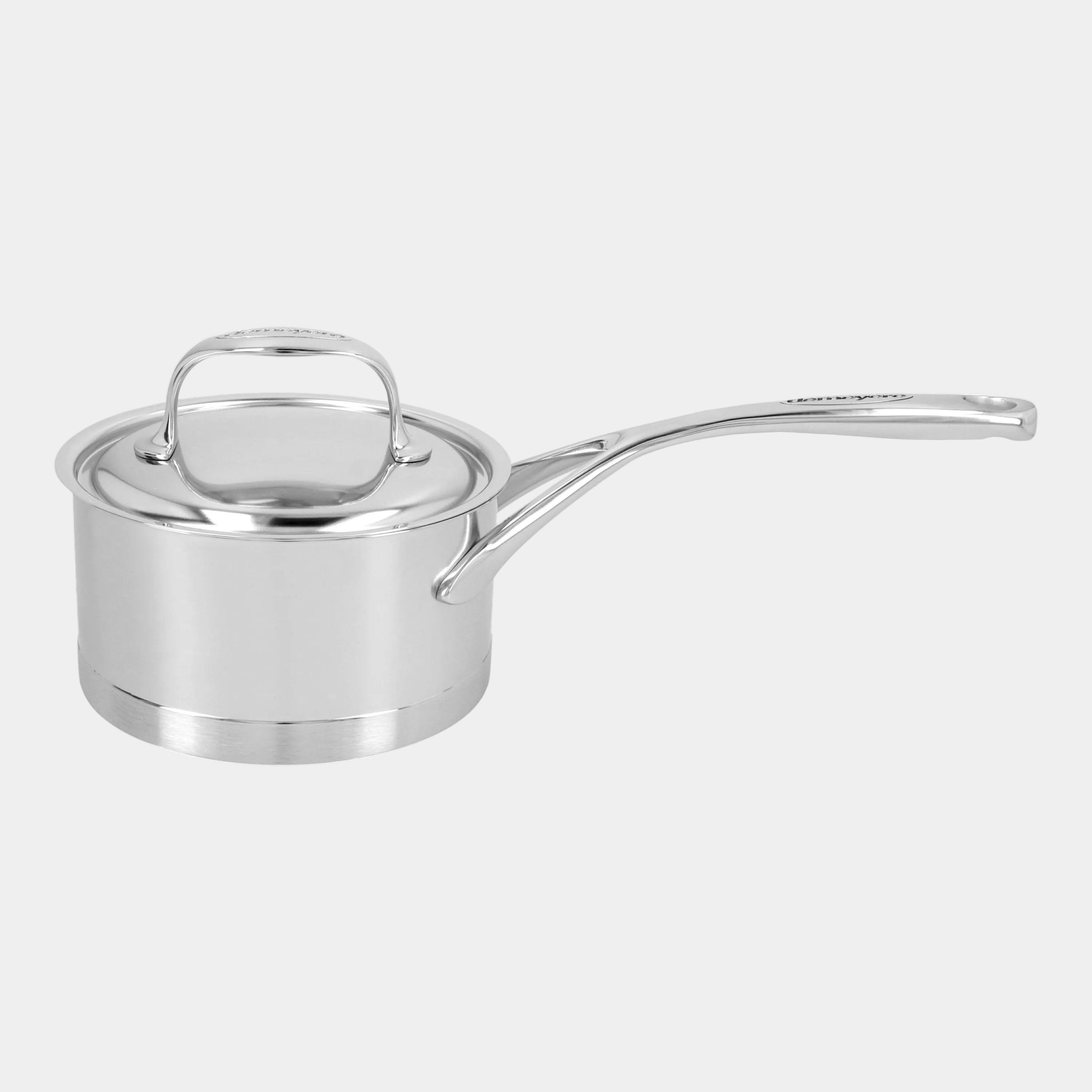 Stainless steel saucepan with lid on a white background
