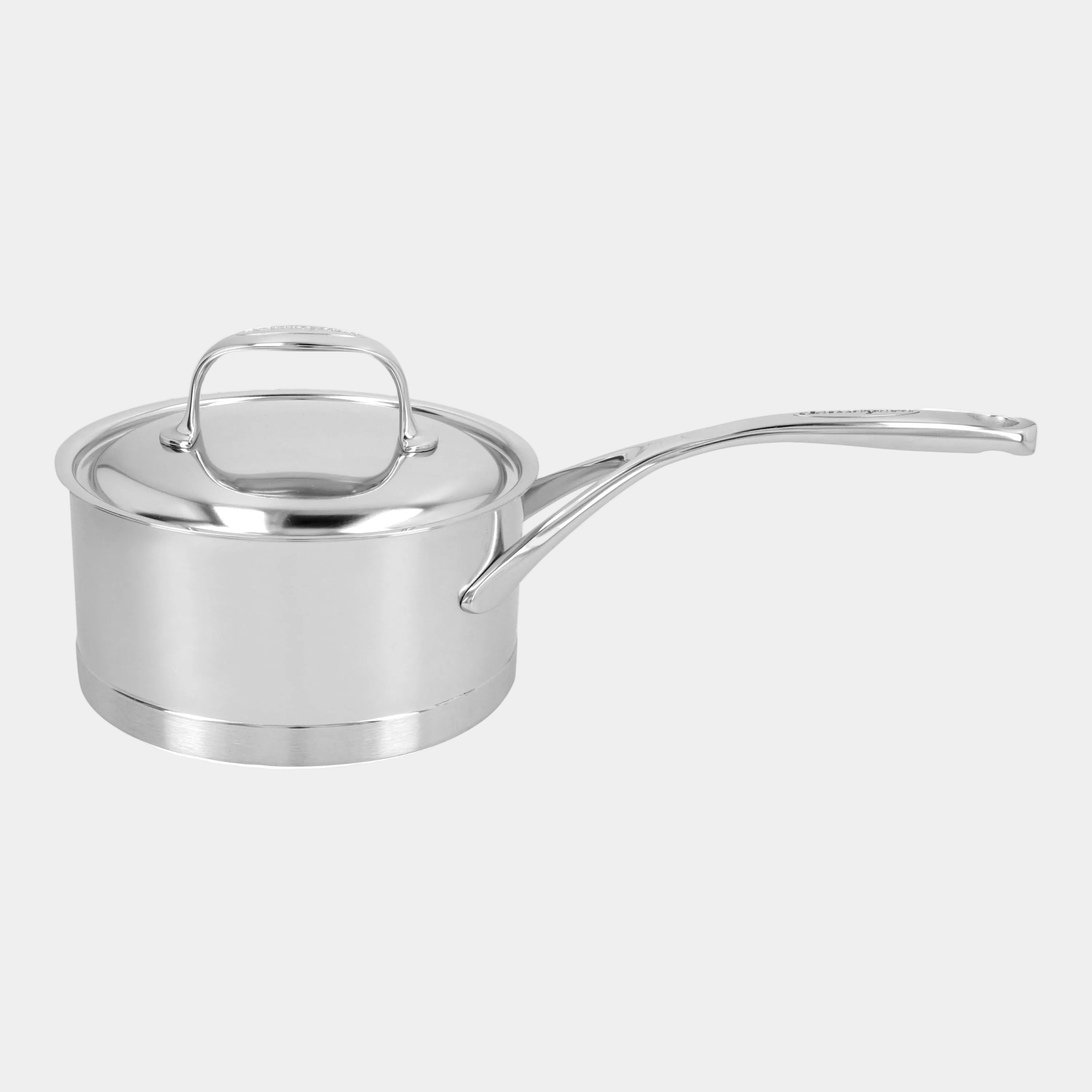 Stainless steel saucepan with lid on a white background