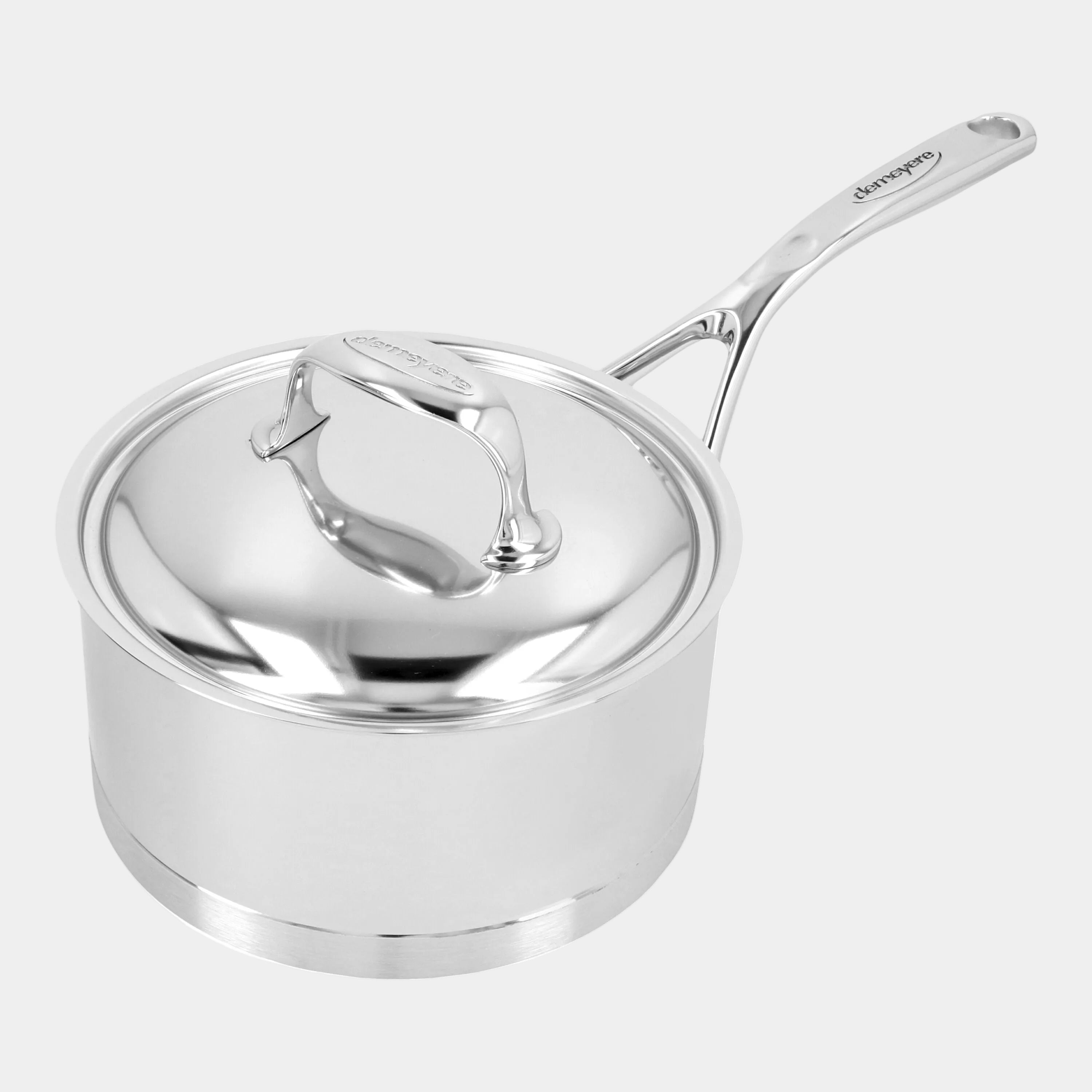 Stainless steel saucepan with lid on a white background