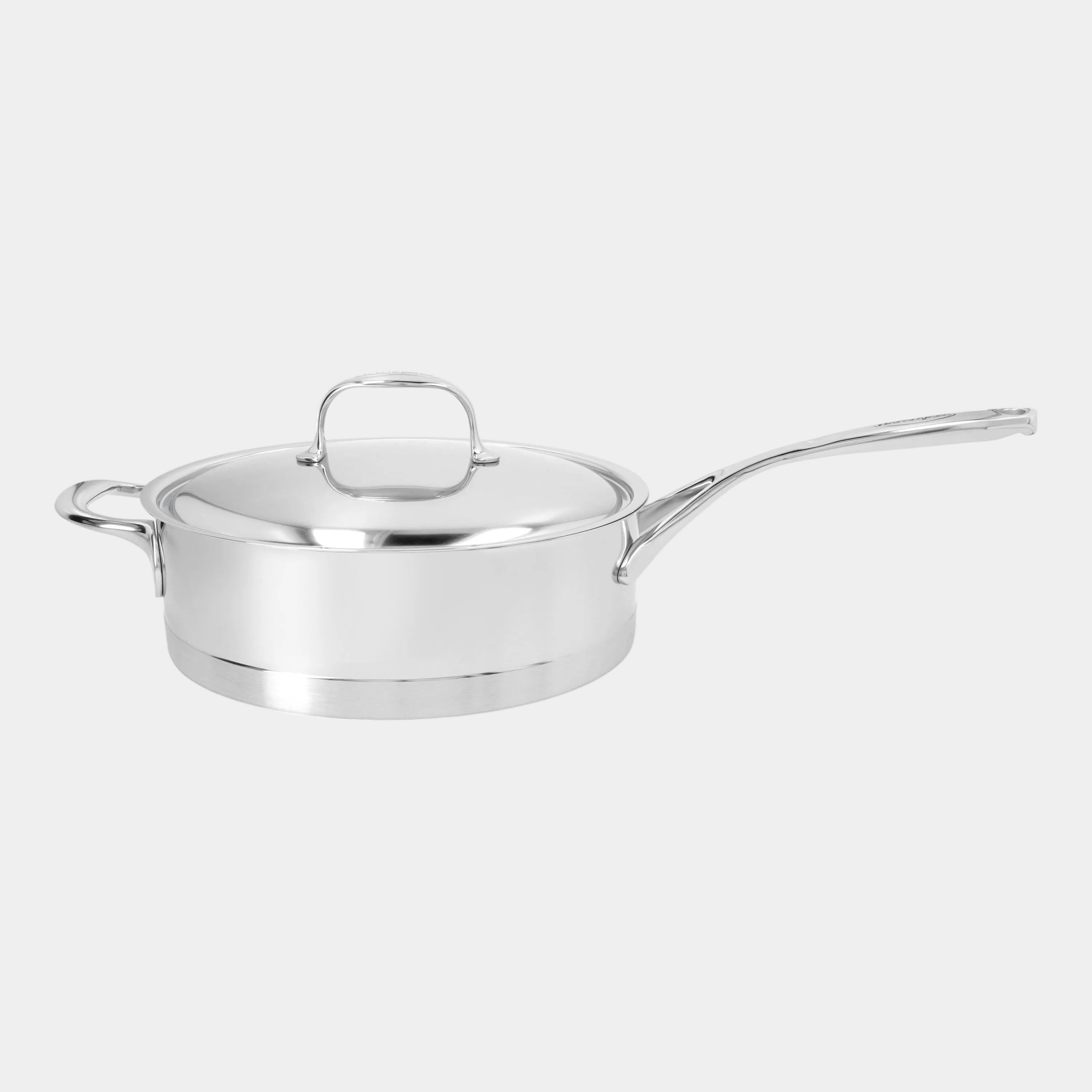 Stainless steel saucepan with lid on a white background