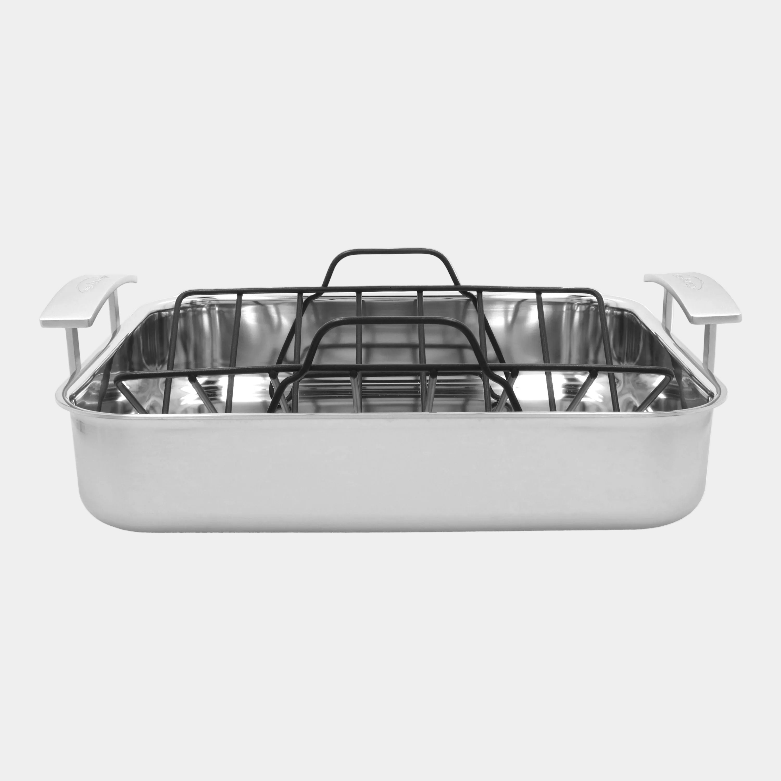 Stainless steel roasting pan with rack on a white background