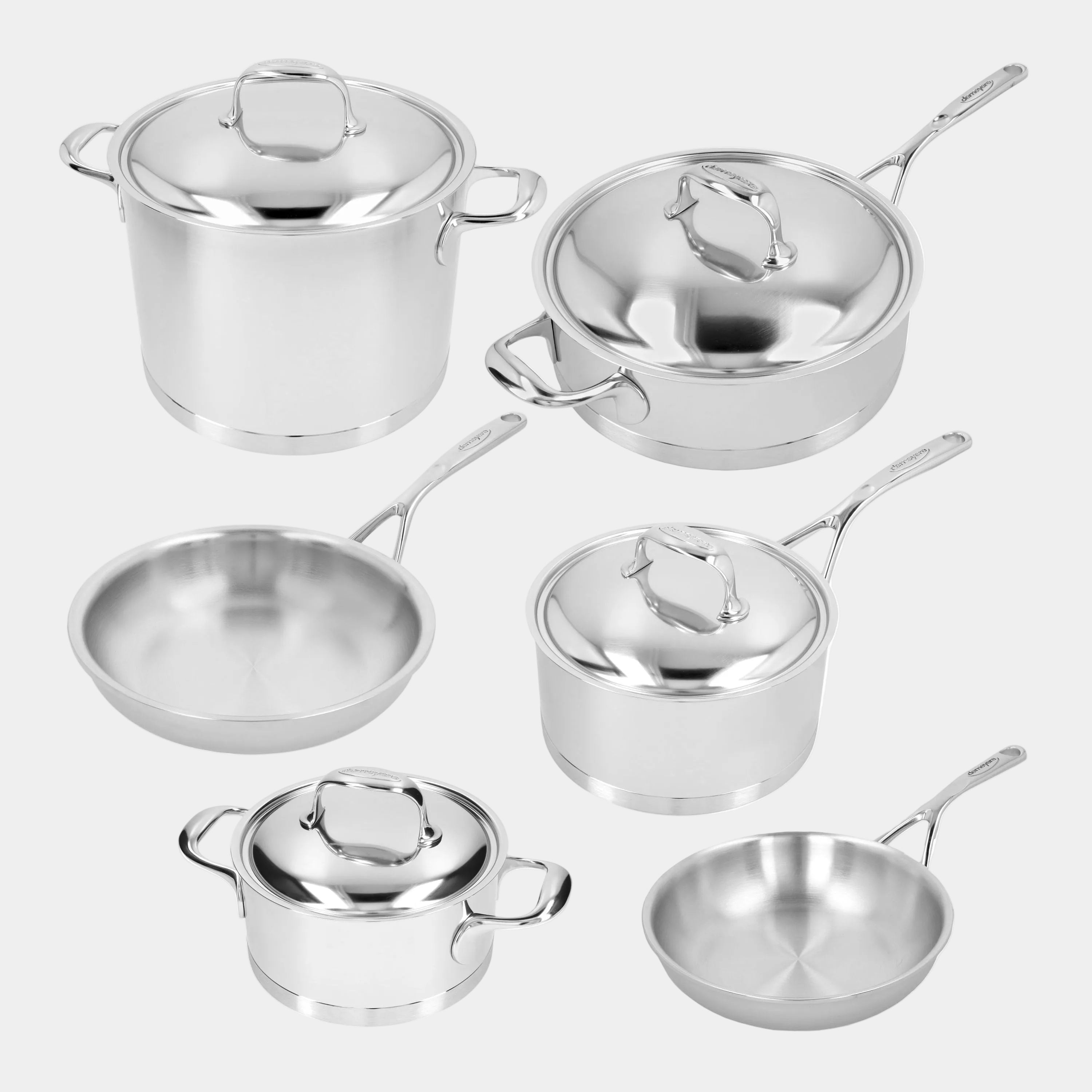 Set of stainless steel cookware including pots and pans on a white background