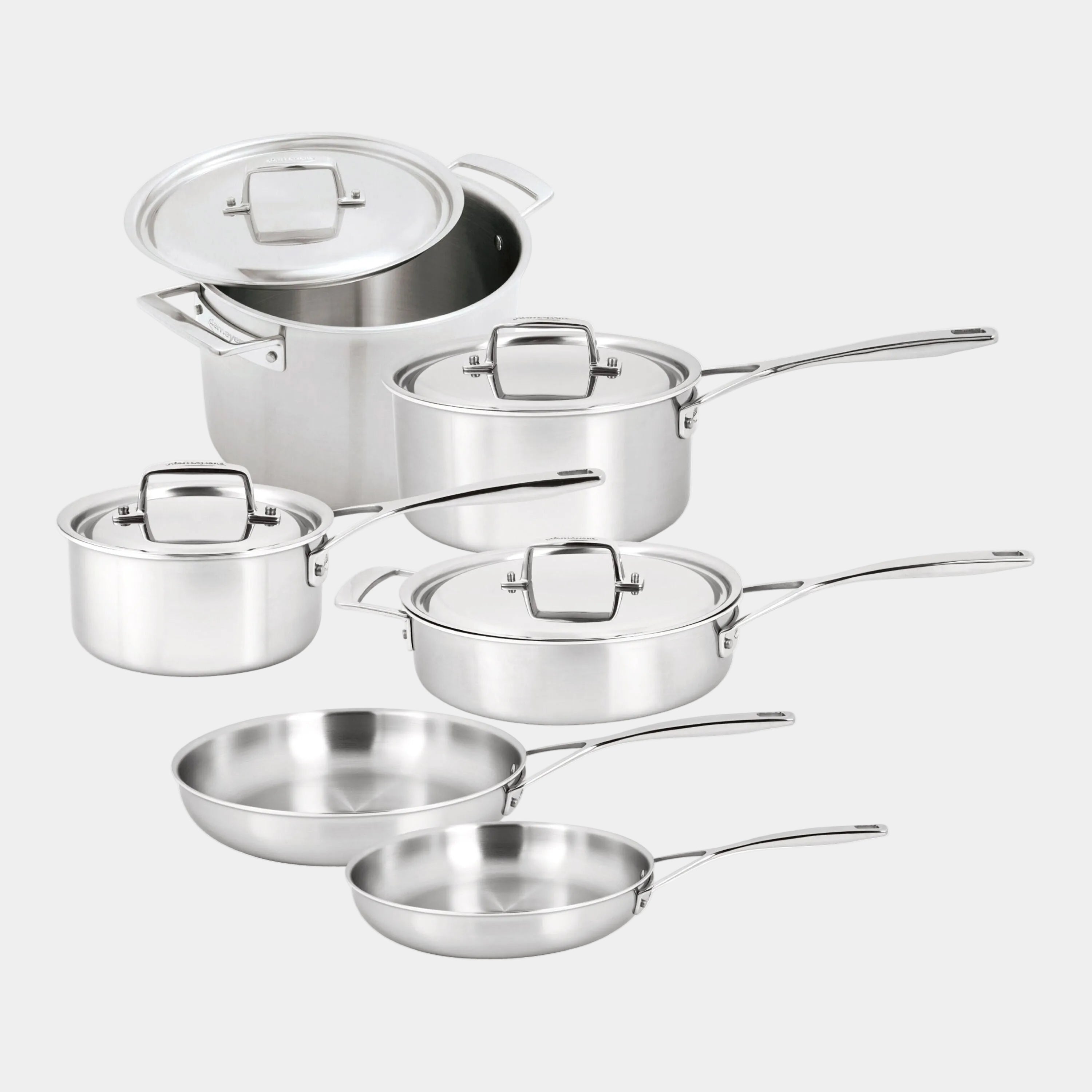 Set of stainless steel cookware with lids on a white background