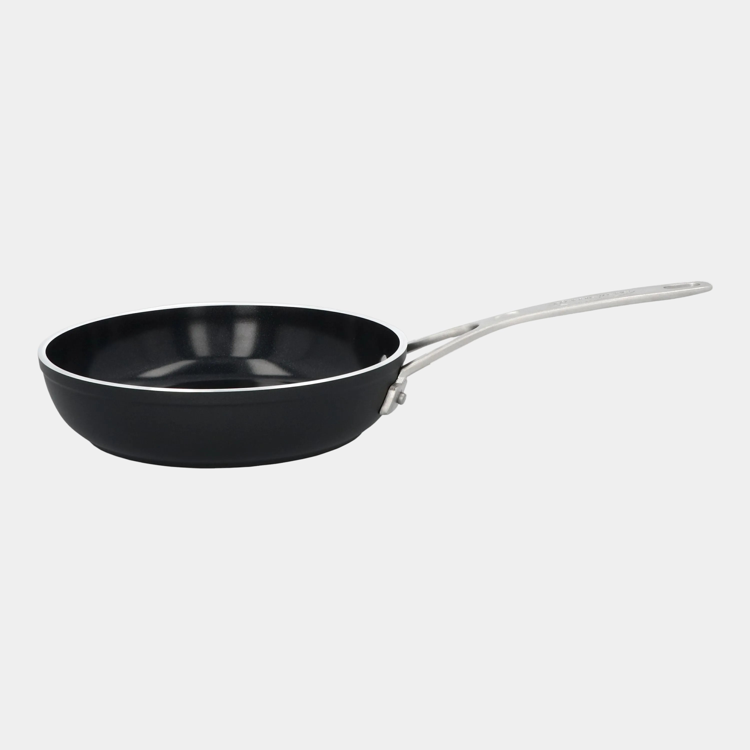 Black frying pan with a silver handle on a white background