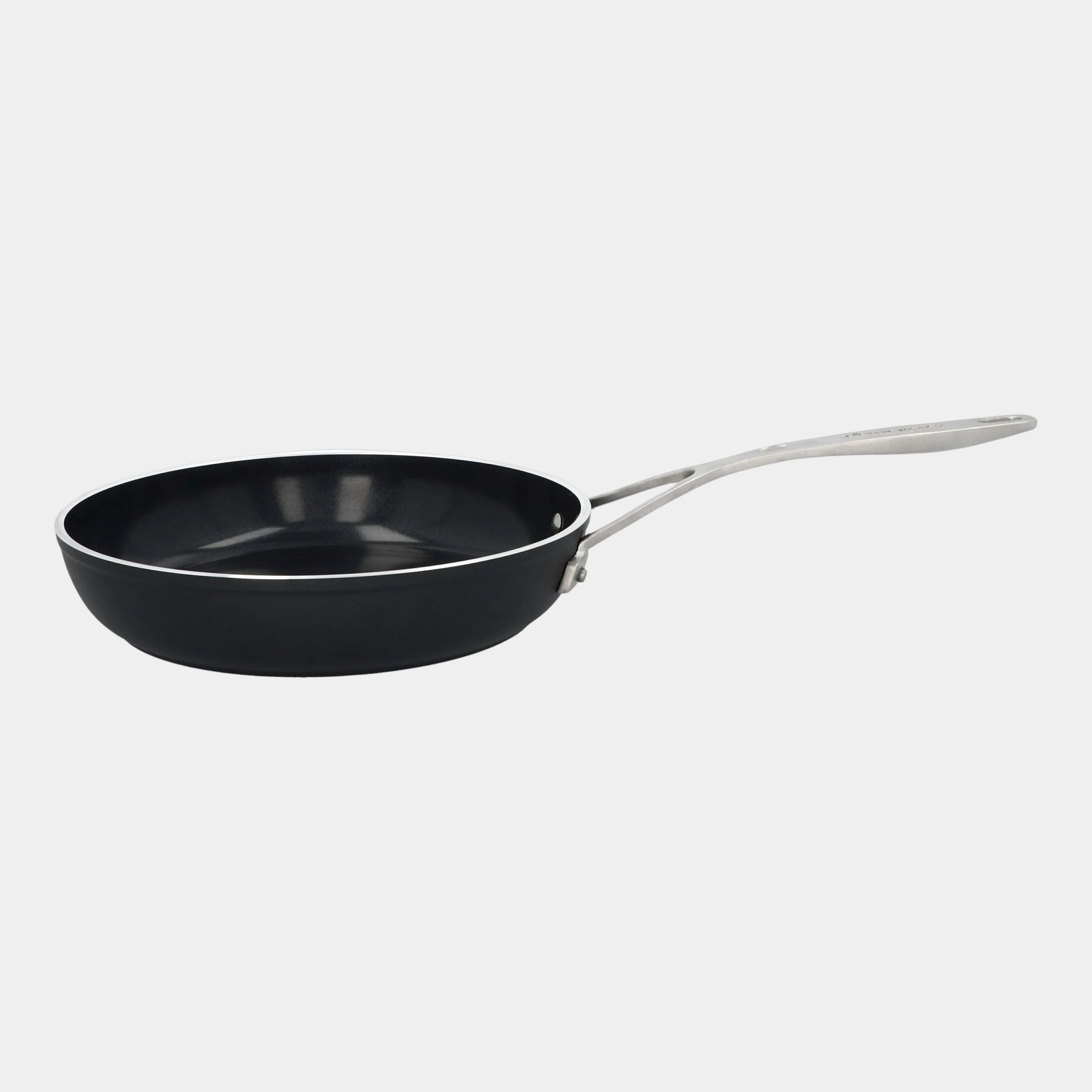 Black frying pan with a silver handle on a white background