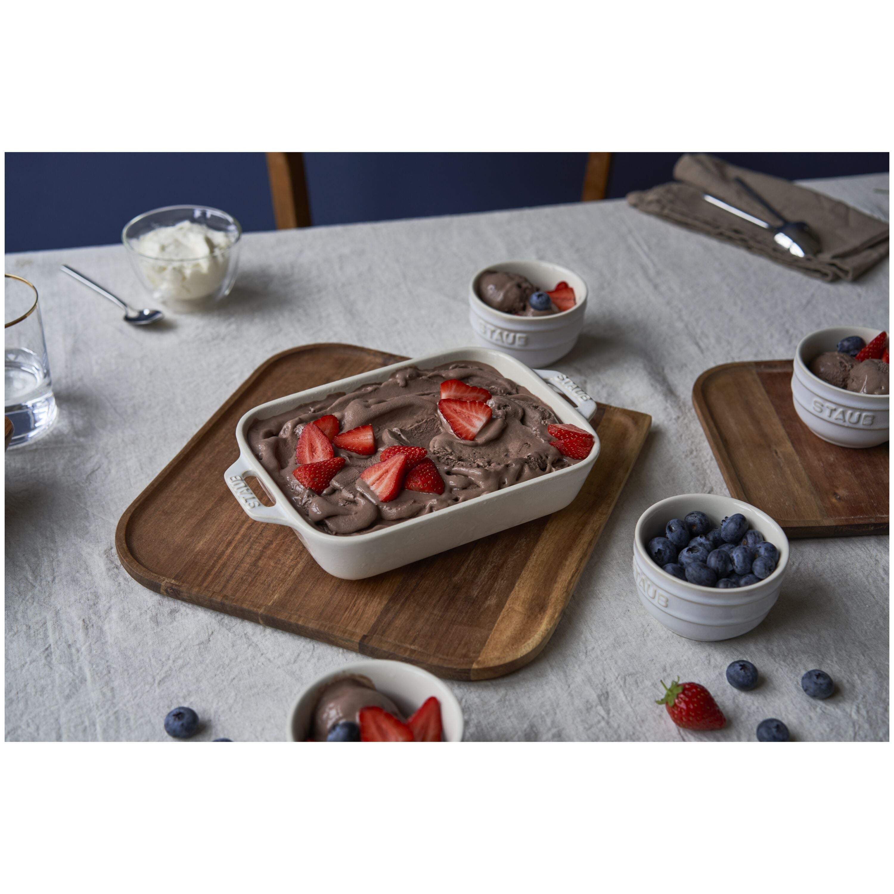 STAUB Ceramique Ceramic Rectangular Oven Dish filled with dessert and topped with strawberries on a wooden serving tray.