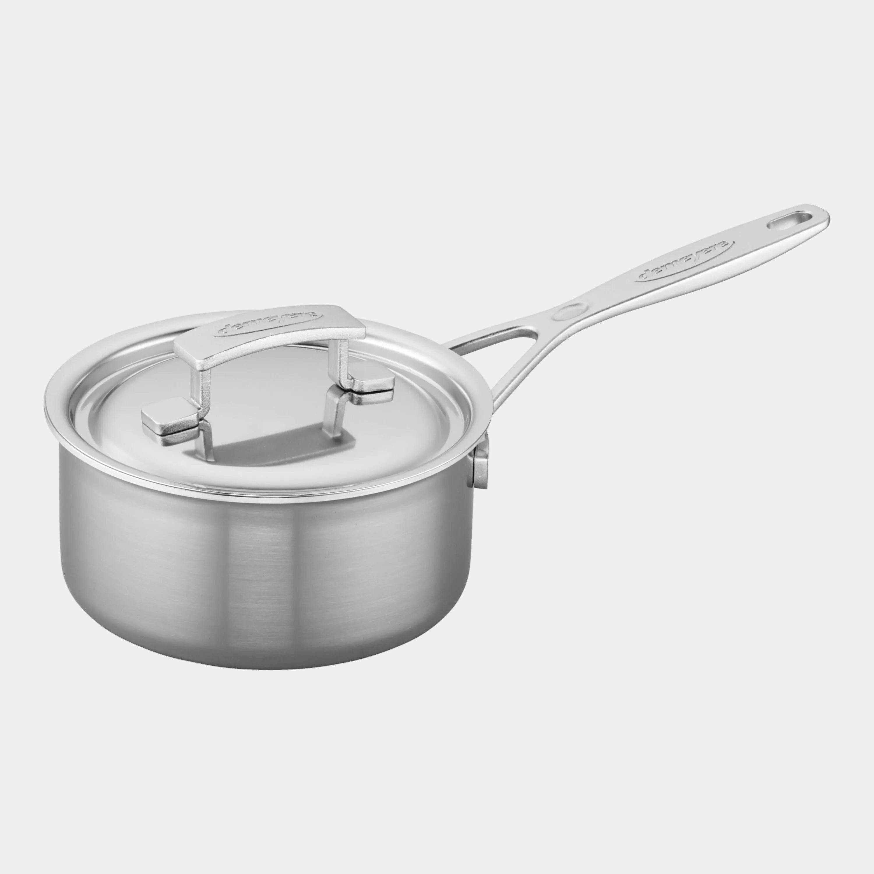 Stainless steel saucepan with lid on a white background