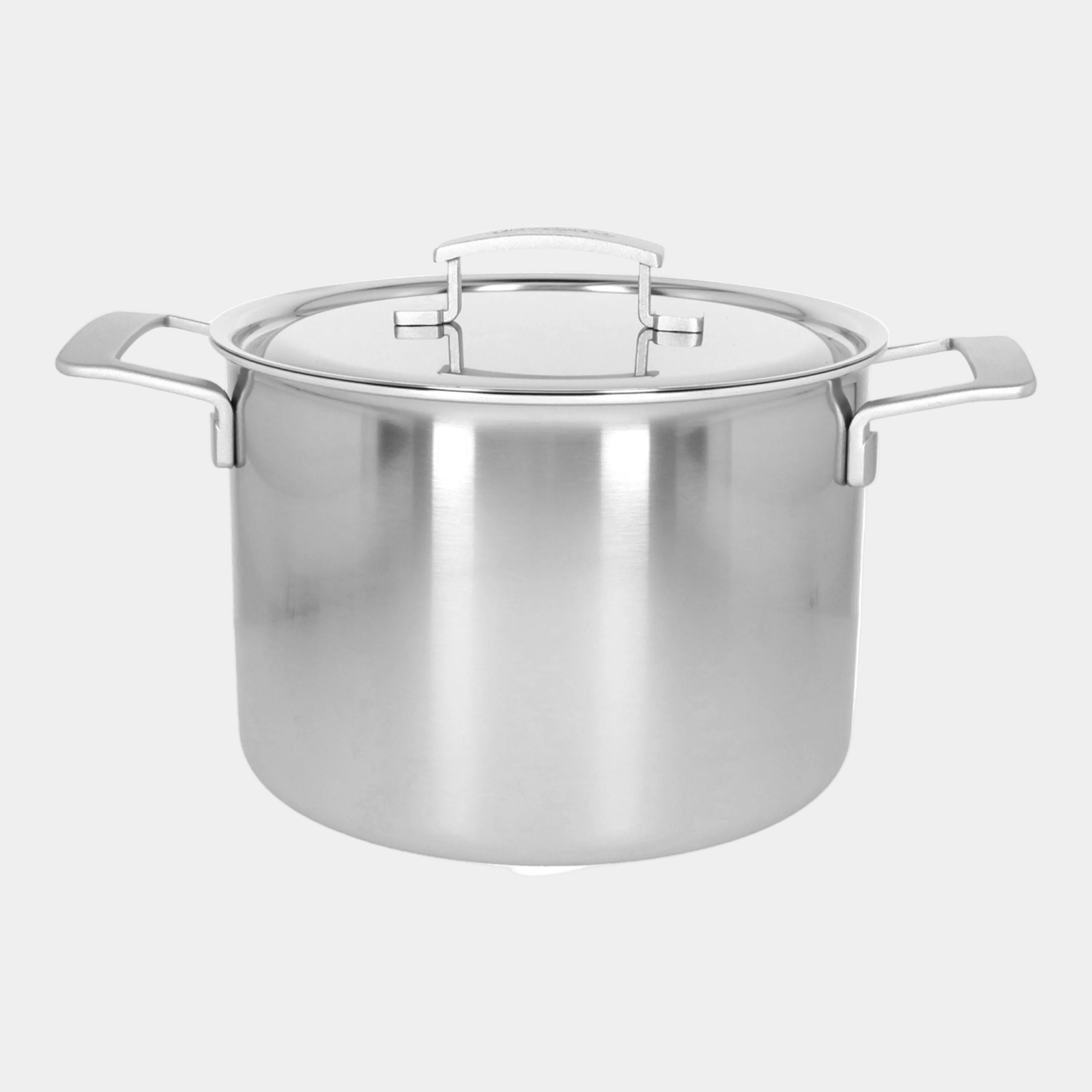 Stainless steel stock pot with lid on a white background