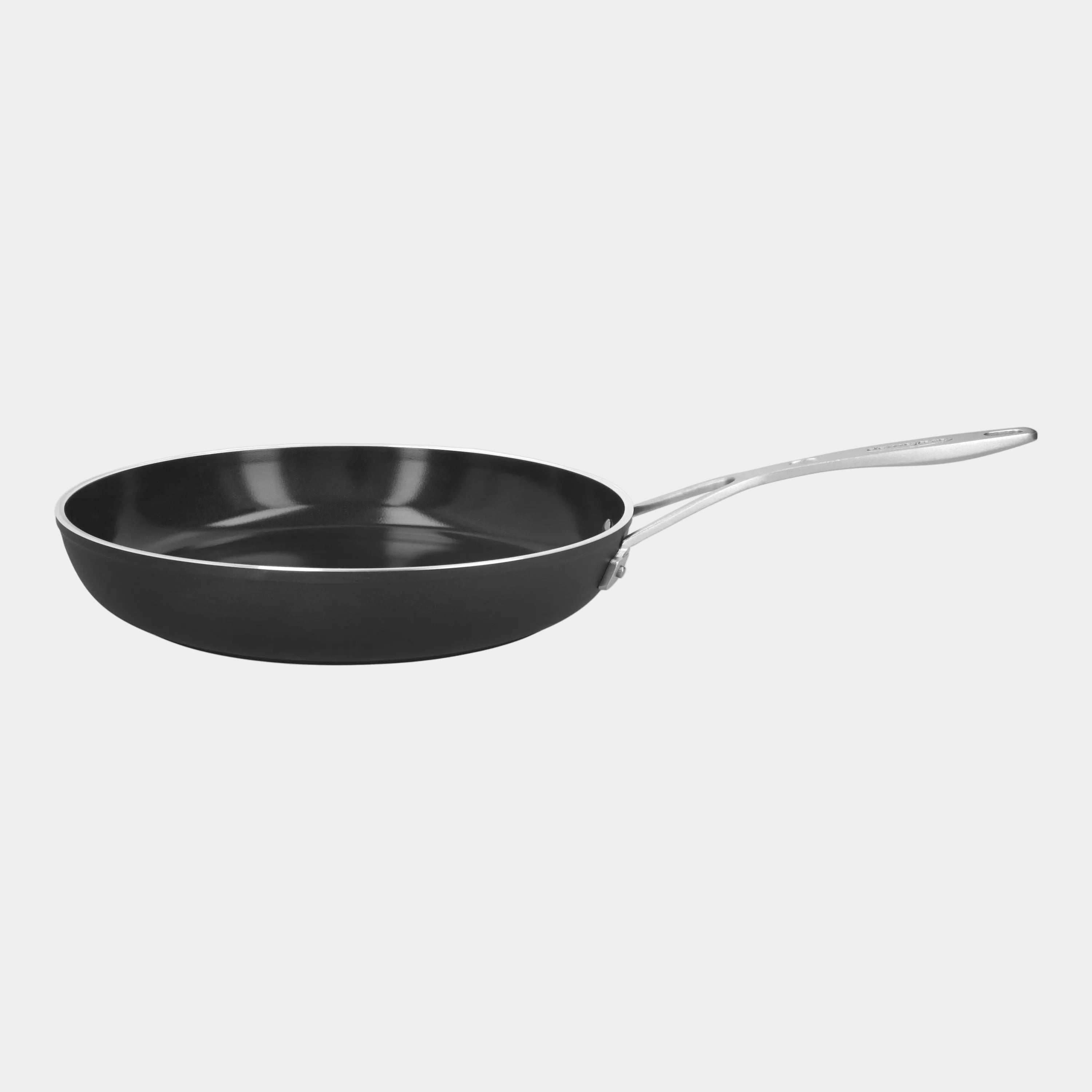 Black frying pan with a silver handle on a white background