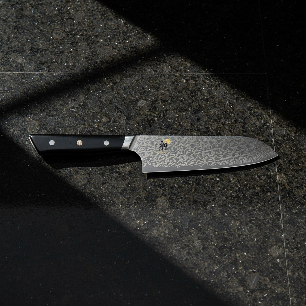 Chef's knife with a decorative blade pattern on a white background