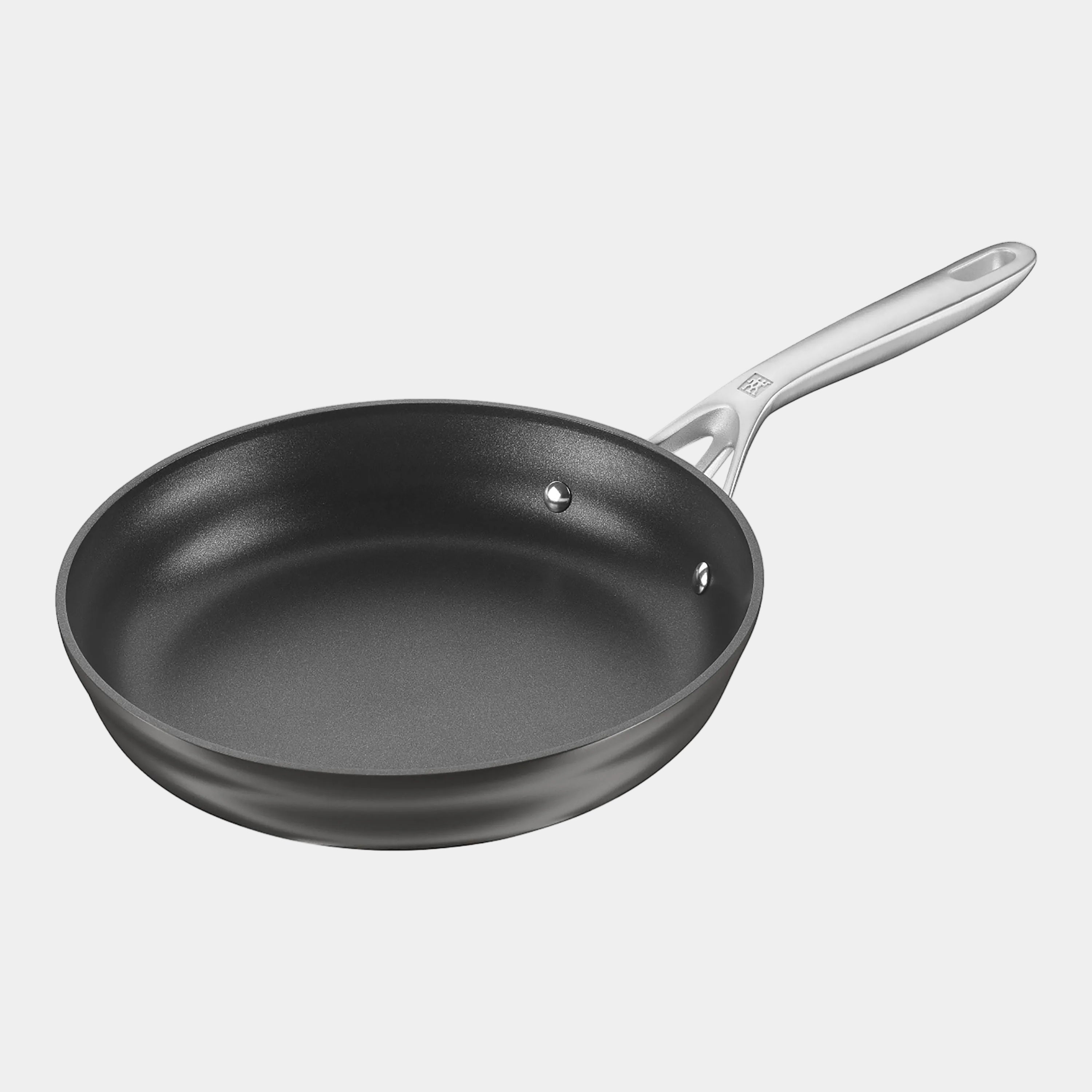 Black frying pan with a silver handle on a white background