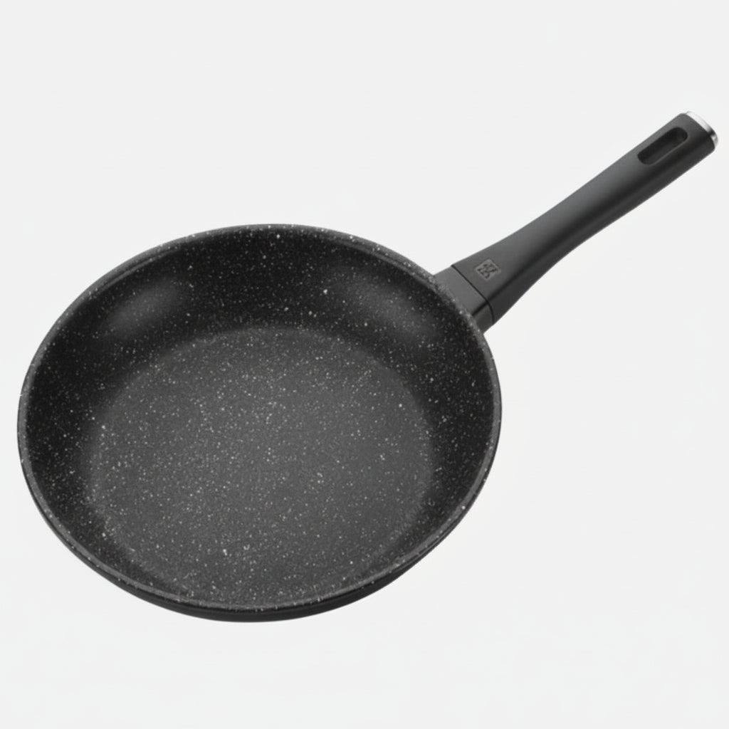 Black frying pan on a light gray background