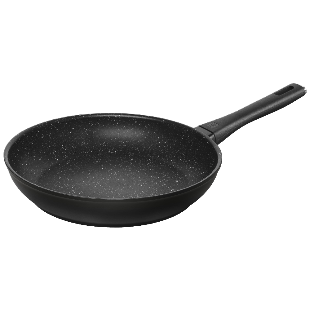 Black frying pan with speckled pattern on a white background