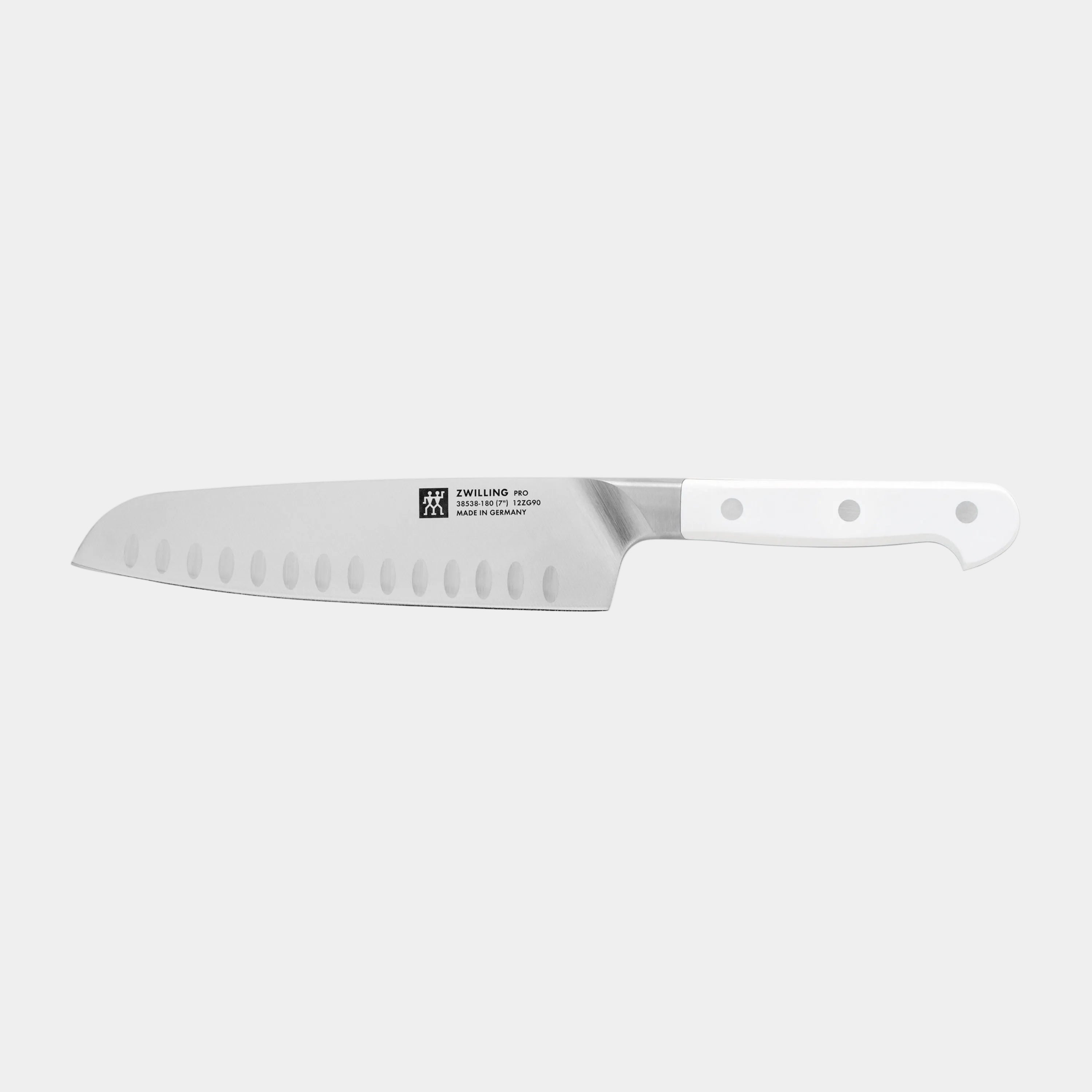Serrated knife with a white handle on a white background