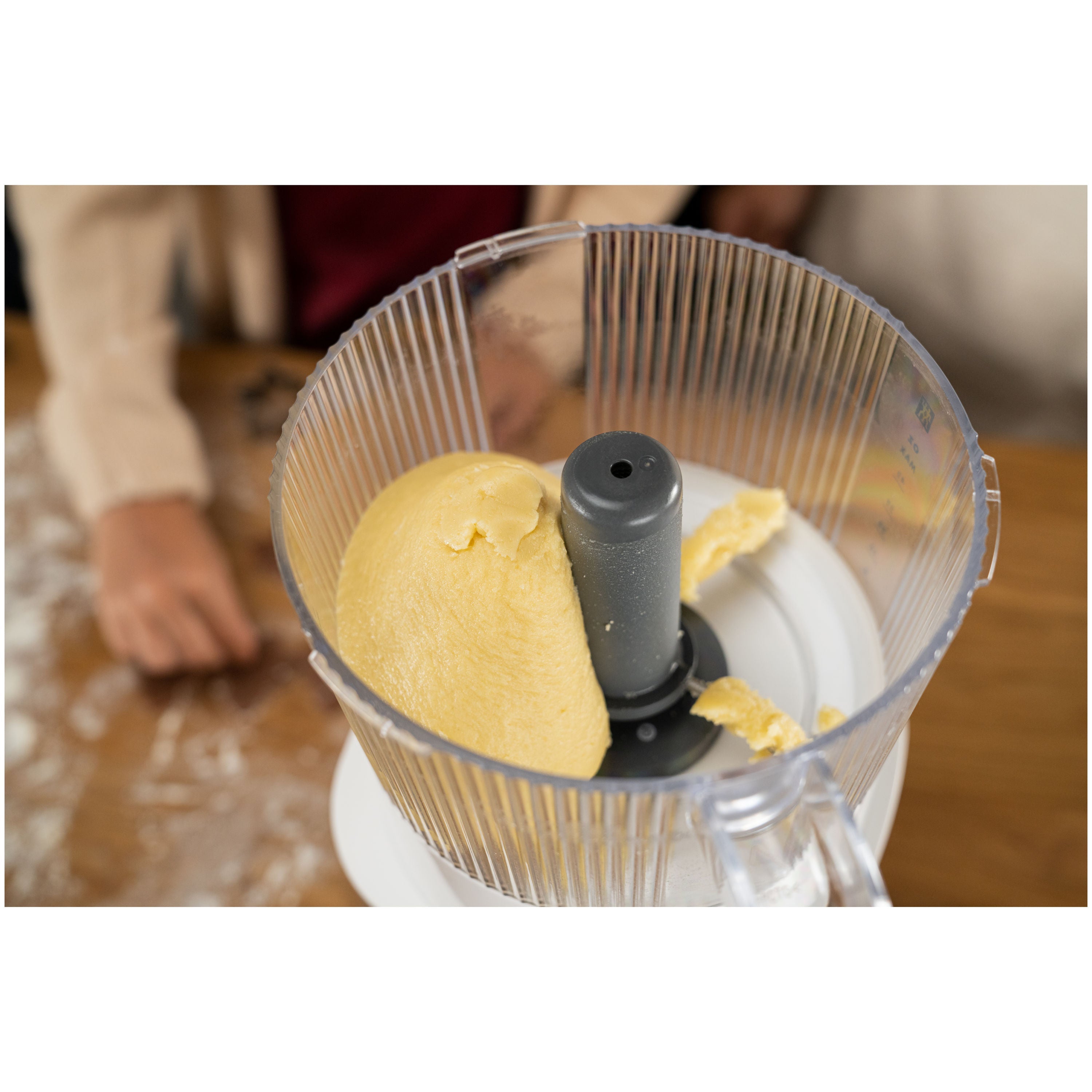 ZWILLING Enfinigy Food Processor Attachment mixing dough in a transparent container, showcasing kitchen versatility.
