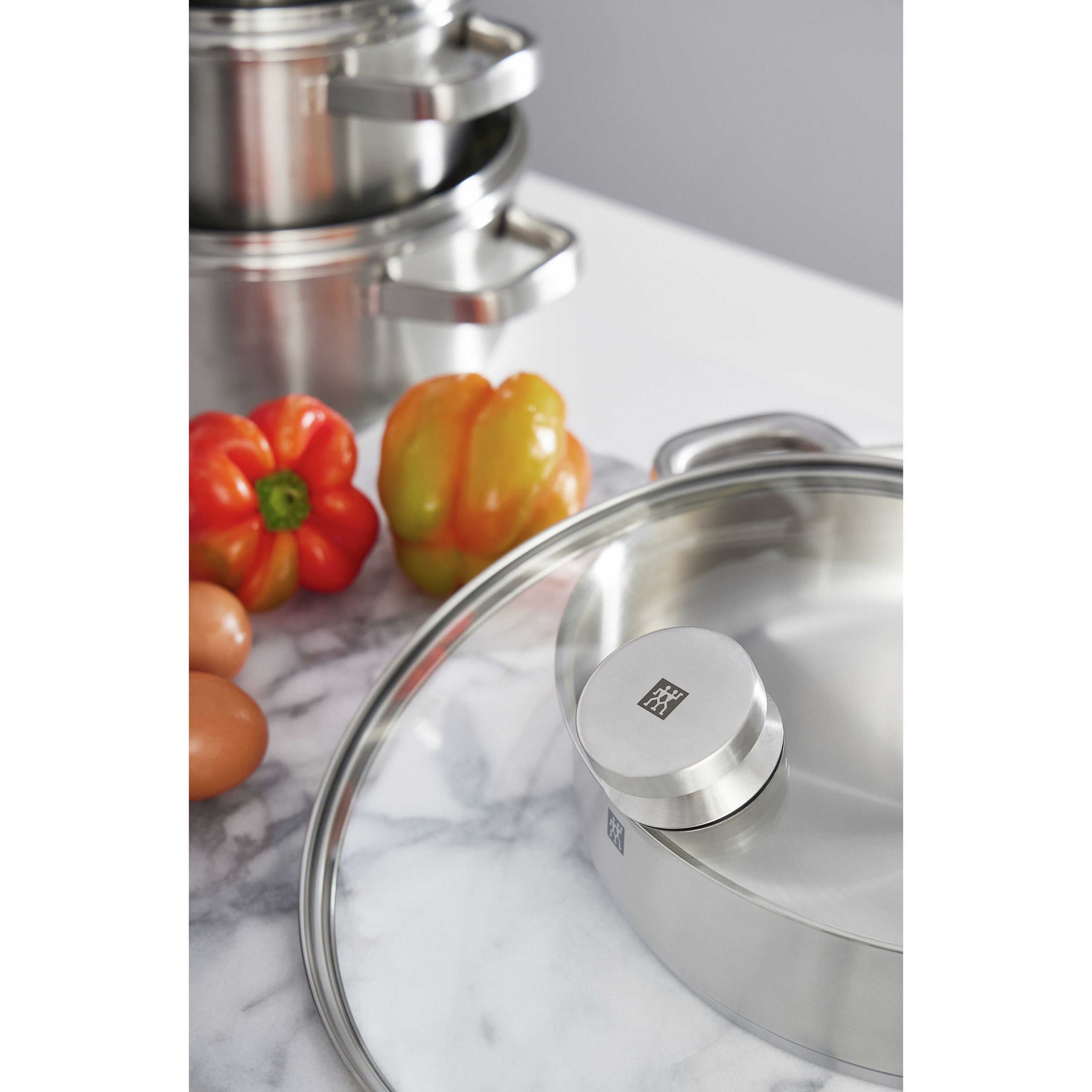Stainless steel Cooking with the Zwilling Joy 4.25 qt Saute Casserole set with a lid on a marble surface