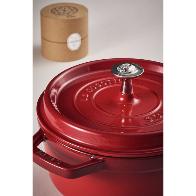 Red Staub cocotte with a wooden box in the background