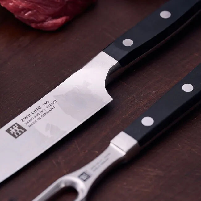 ZWILLING Pro Knife Set 2 Piece showing premium stainless steel blades on a wooden background.