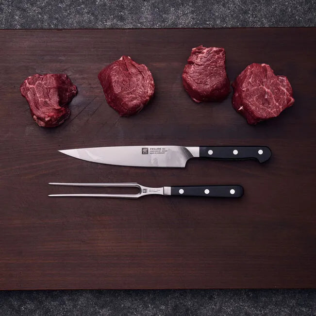 ZWILLING Pro Knife Set 2 Piece on cutting board with raw meat for culinary precision.