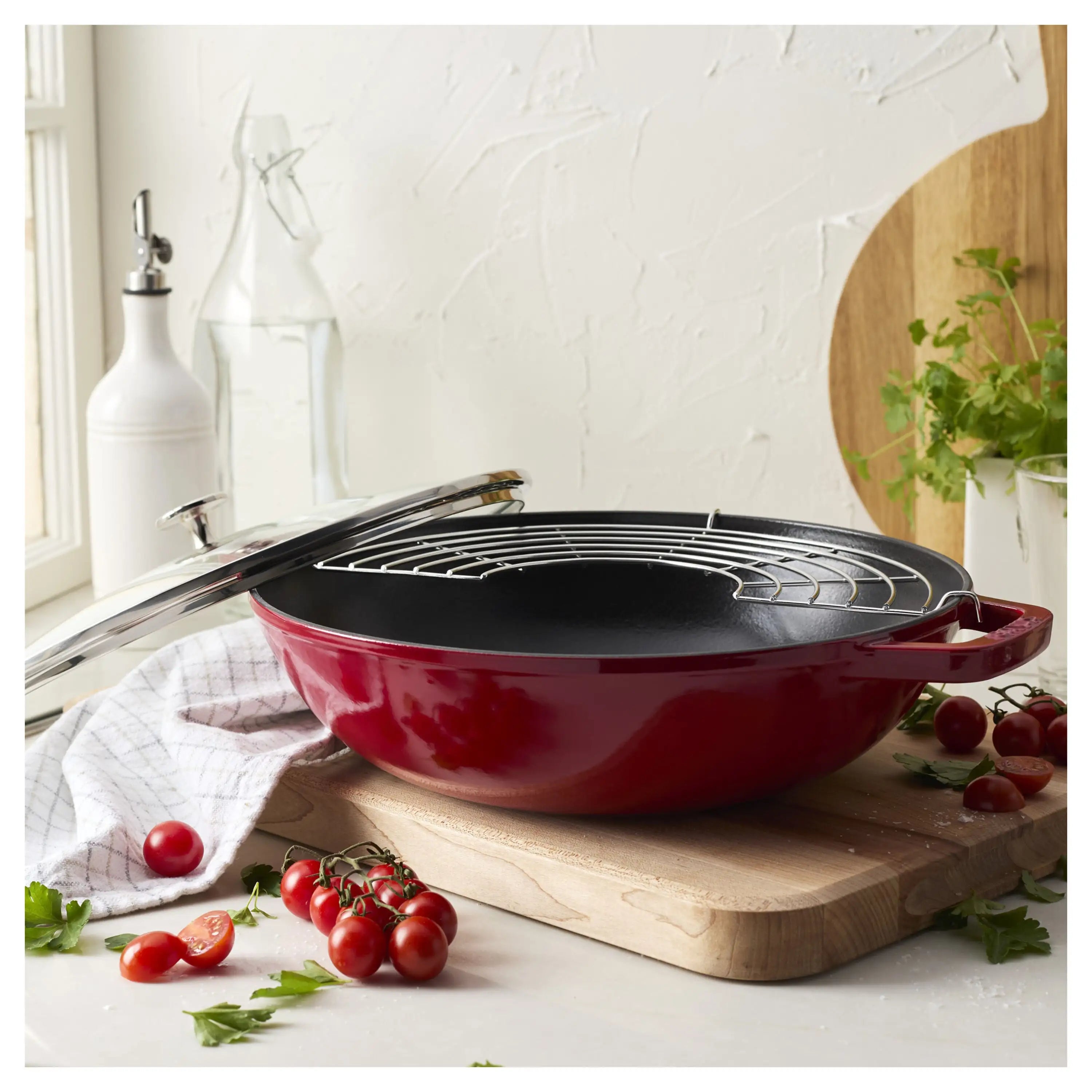STAUB Specialities Cast Iron Wok with Glass Lid in Cherry color on kitchen counter
