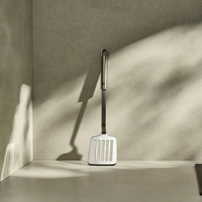 ZWILLING Pro Frying Pan Turner, 35 cm spatula in stainless steel on a kitchen counter.