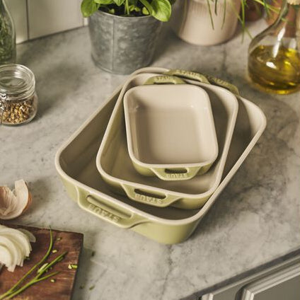 STAUB Macaron Baker Set Rectangulart on a kitchen countertop with stacked rectangular dishes.