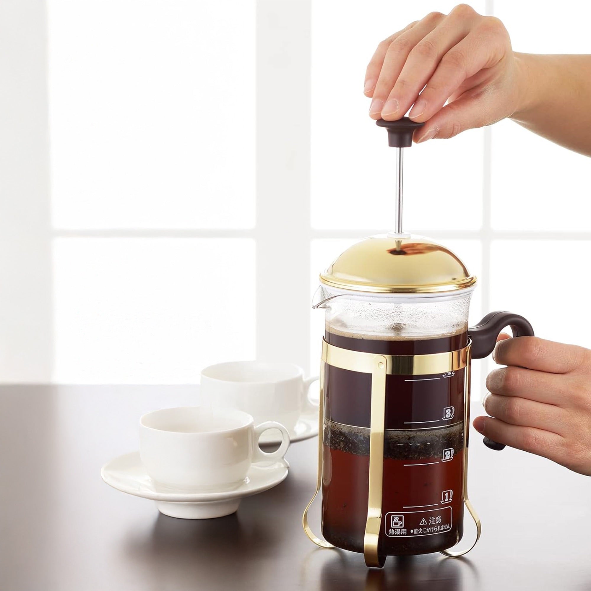 Using the Yoshikawa stainless steel coffee press to brew fresh coffee at home with elegance and precision.