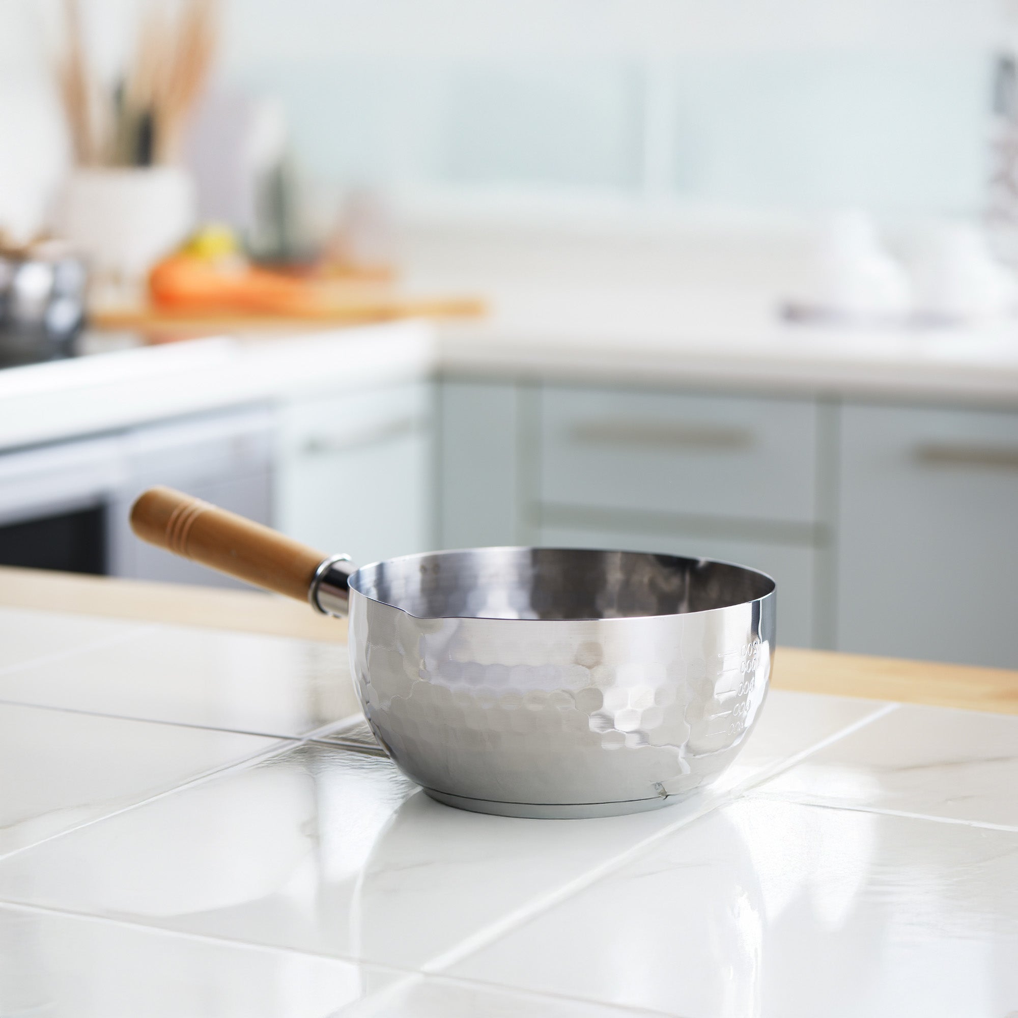 Yoshikawa Yukihira Saucepan set on a kitchen counter, showcasing the hammered stainless steel exterior.