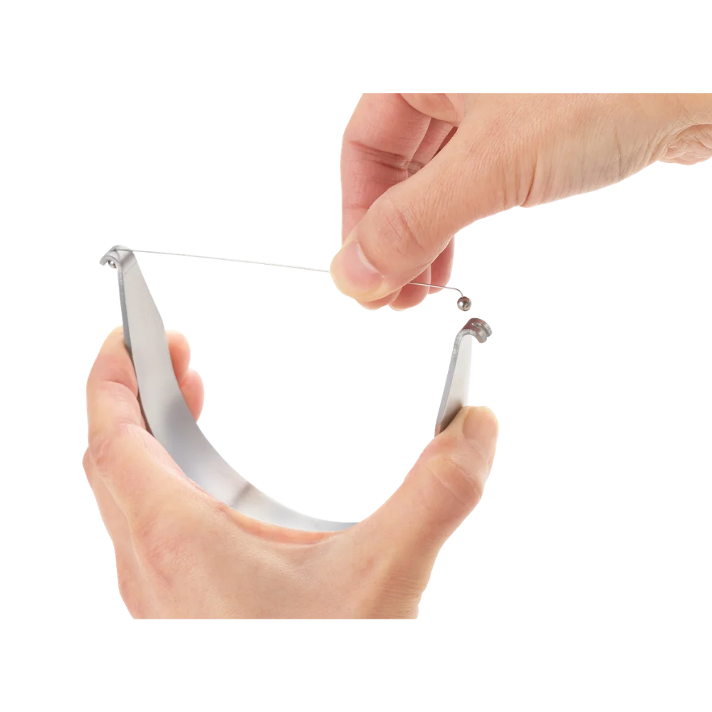 Hands demonstrating the use of EAtoCO Kaku Wire Cheese Cutter, stainless steel, by Yoshikawa, made in Japan for precise cheese slicing.