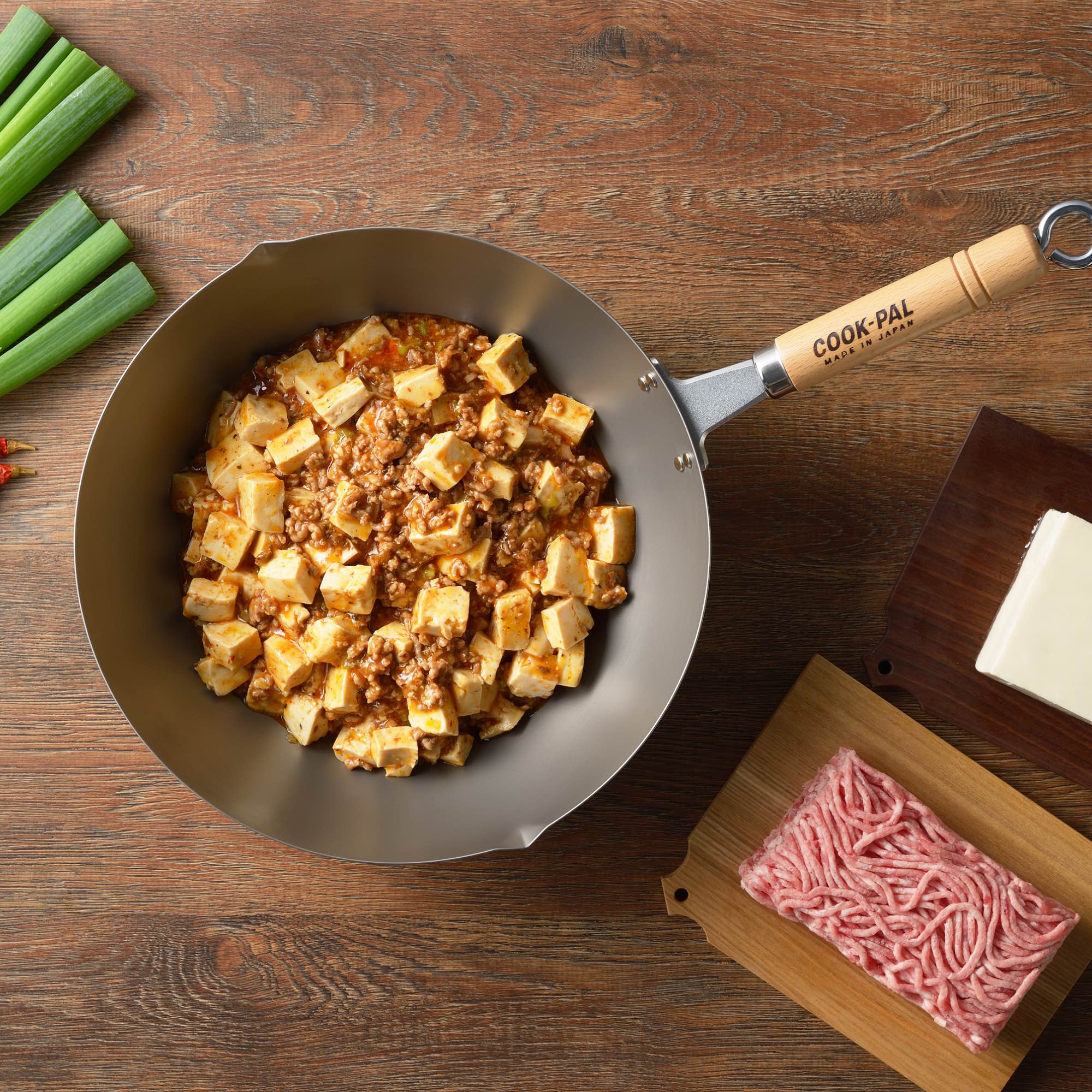 Yoshikawa Titanium wok filled with cooked tofu and meat, showcasing a culinary dish preparation.