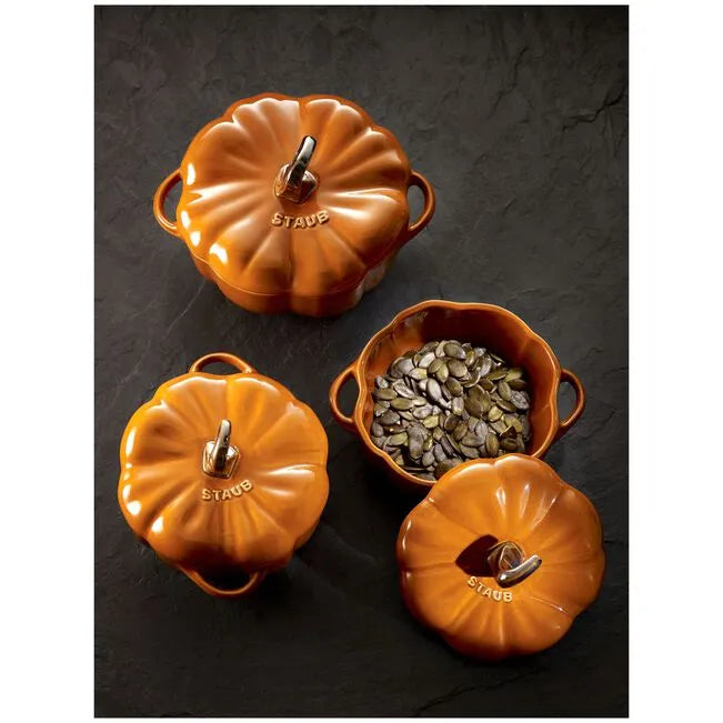 STAUB Ceramique Ceramic Pumpkin Cocotte with decorative seeds showcased.