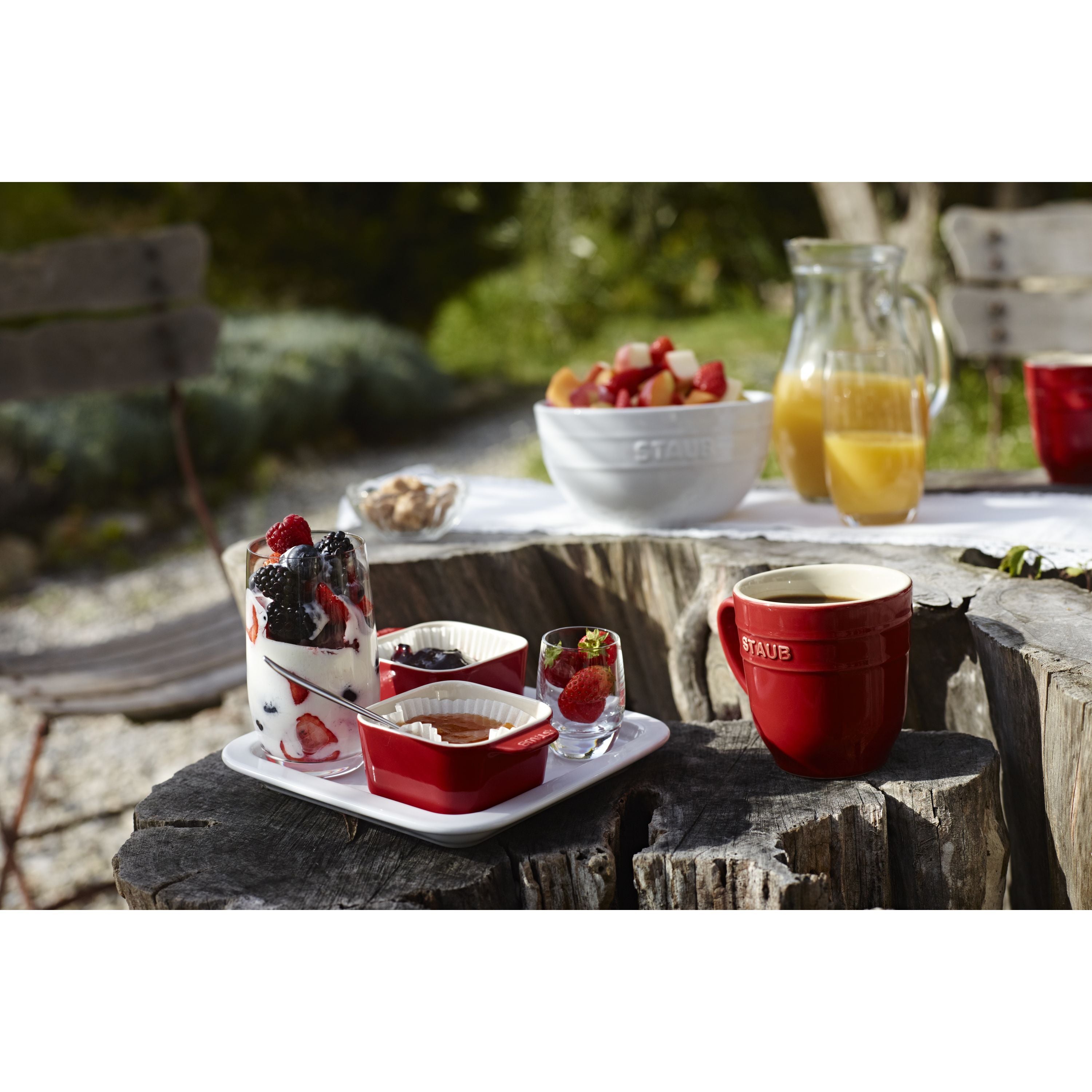 STAUB Ceramique 5 Piece Ceramic Appetiser Set in Cherry with tapas and fruits served outdoors.