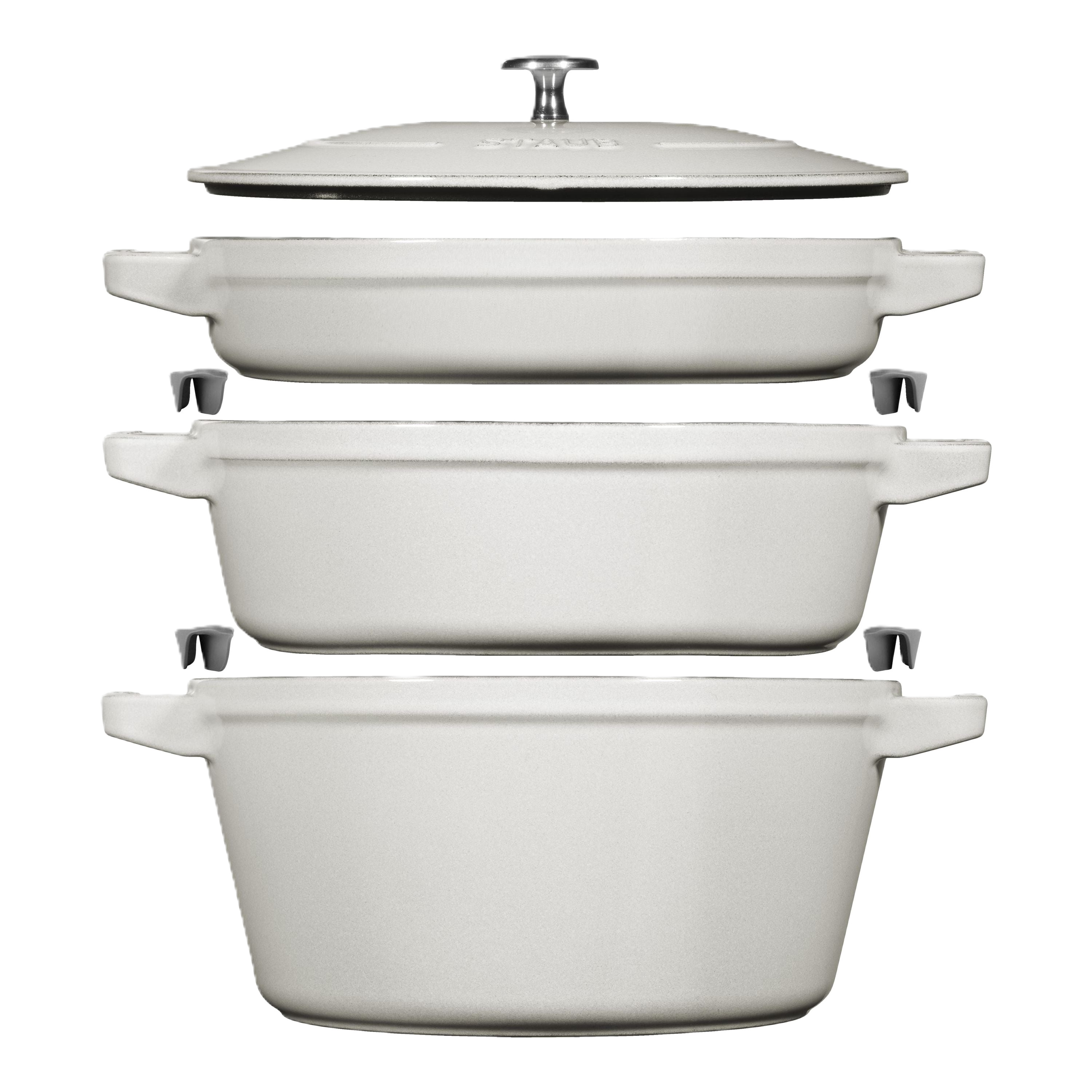 Set of white ceramic cookware pieces on a white background