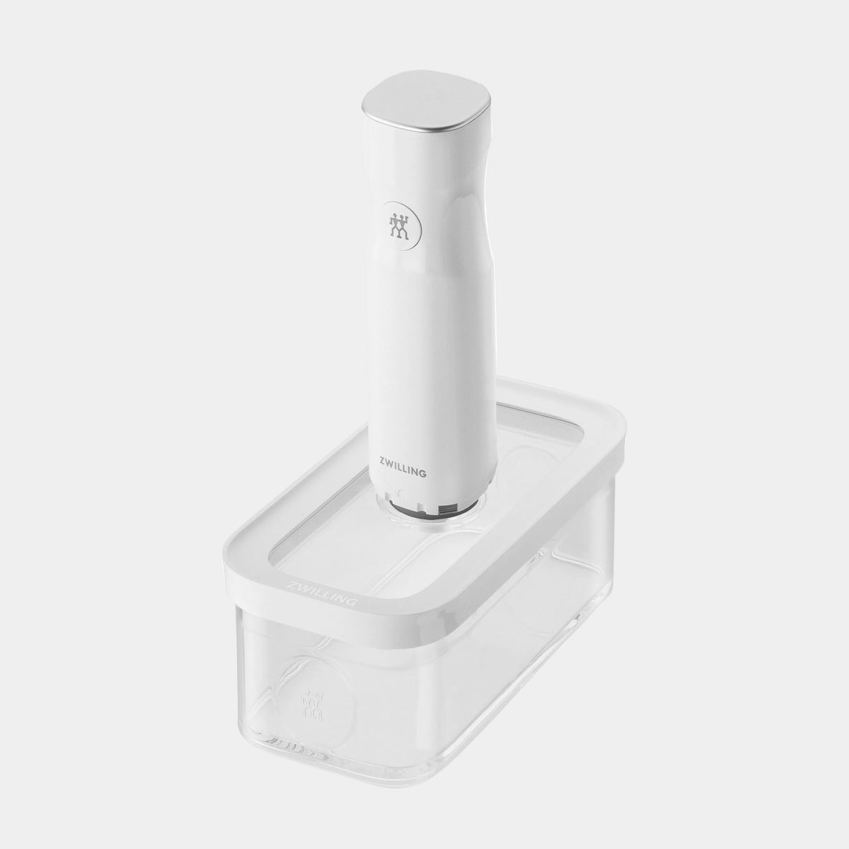 White electric kitchen tool with a clear container on a white background