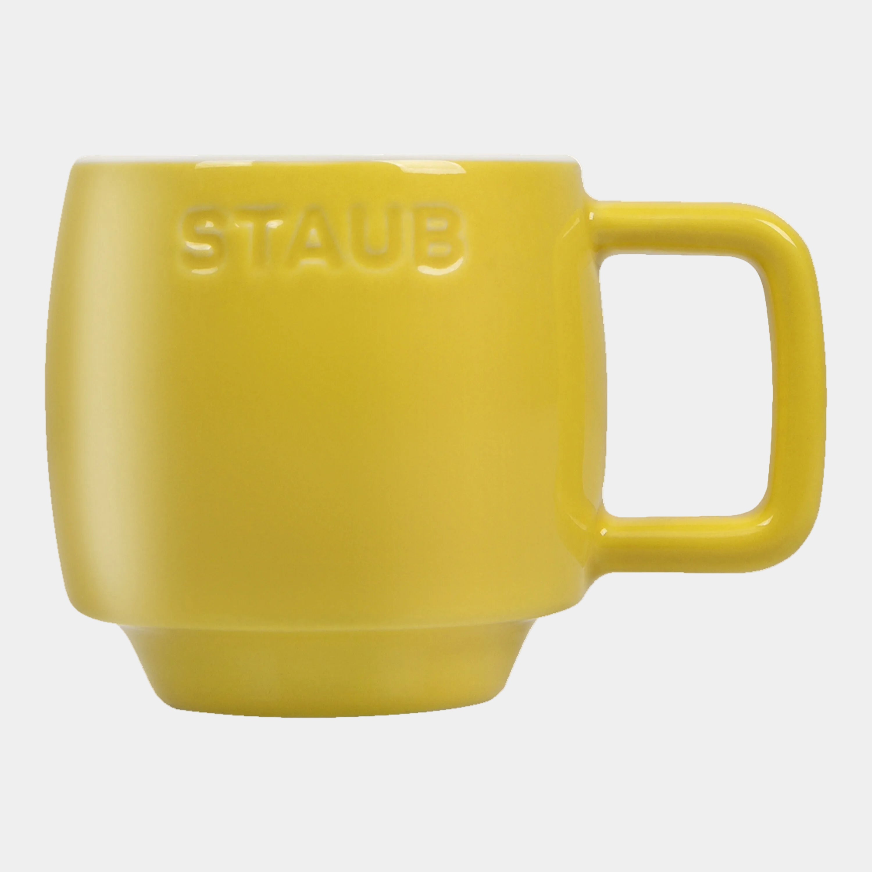 Yellow mug with 'Staub' branding on a white background